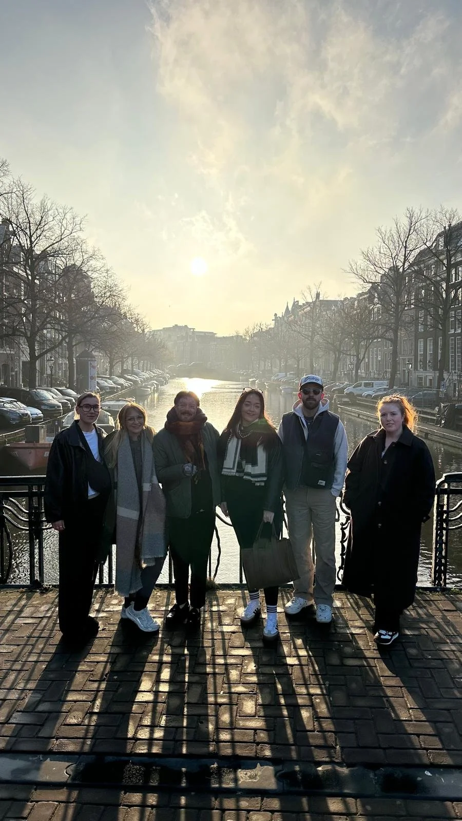 Photo of the Cresswell Barber Co Team standing on a bridge in Amsterdam.