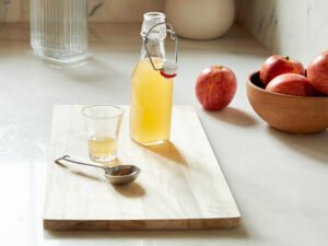 Apple cider vinegar on a chopping board