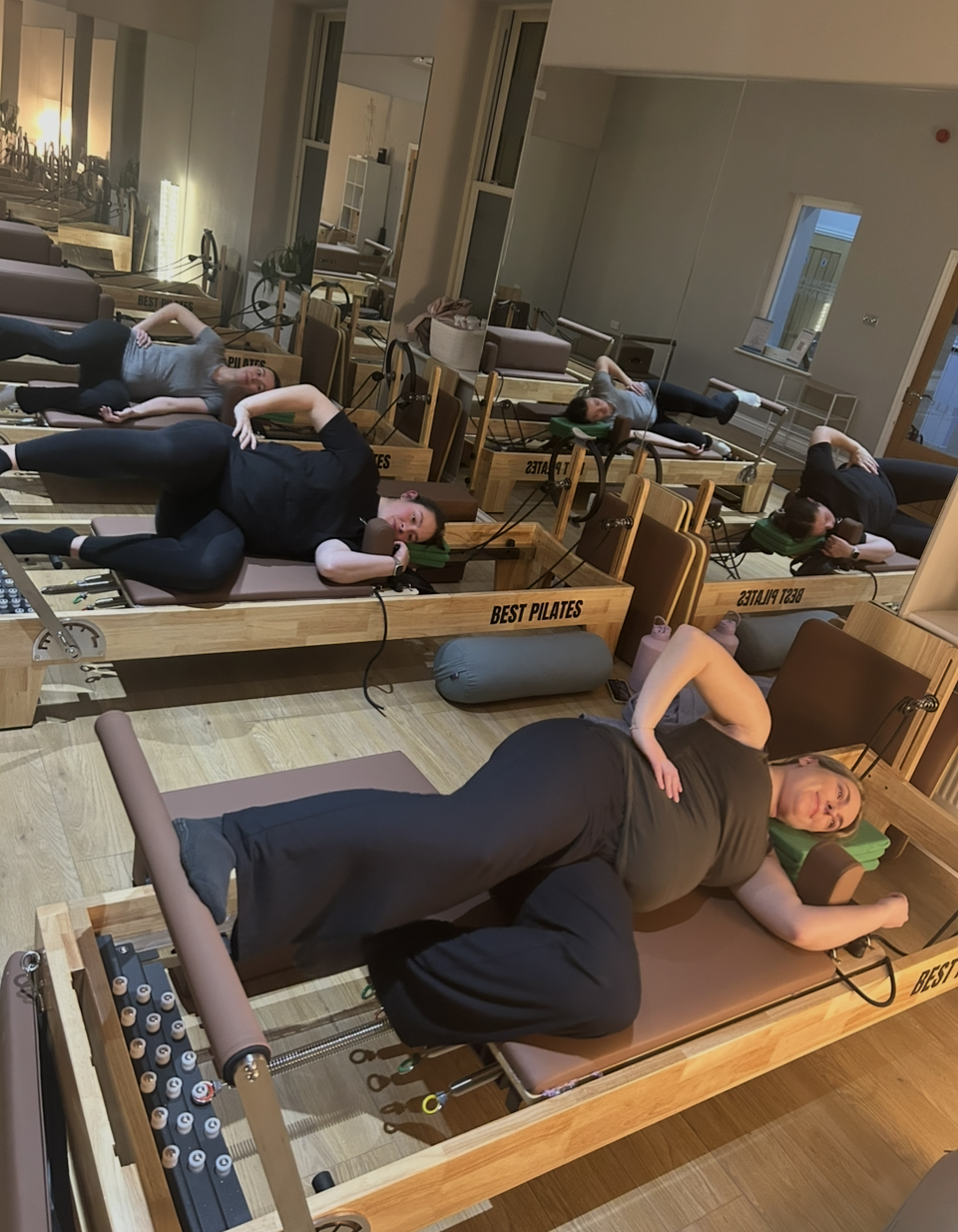 Group of pregnant women doing a reformer Pilates class