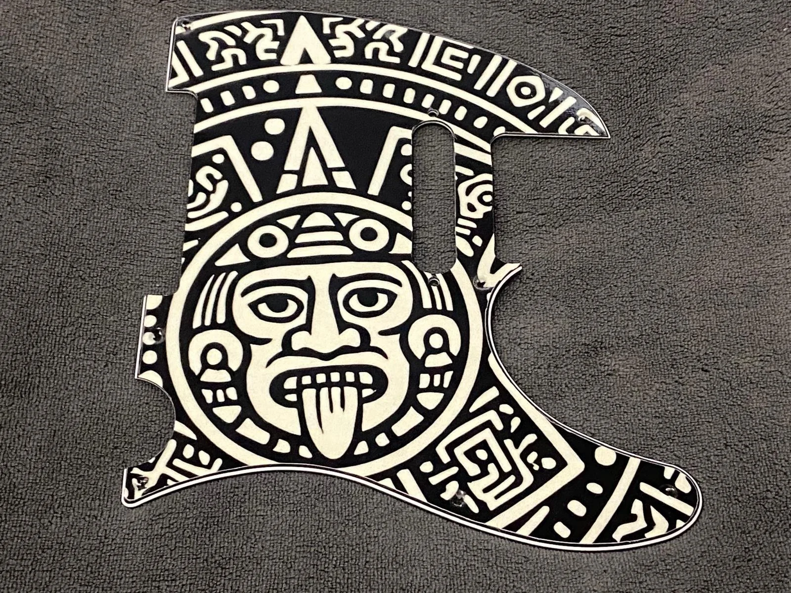 Decorative piece resembling the state of Michigan, featuring a tribal mask design.