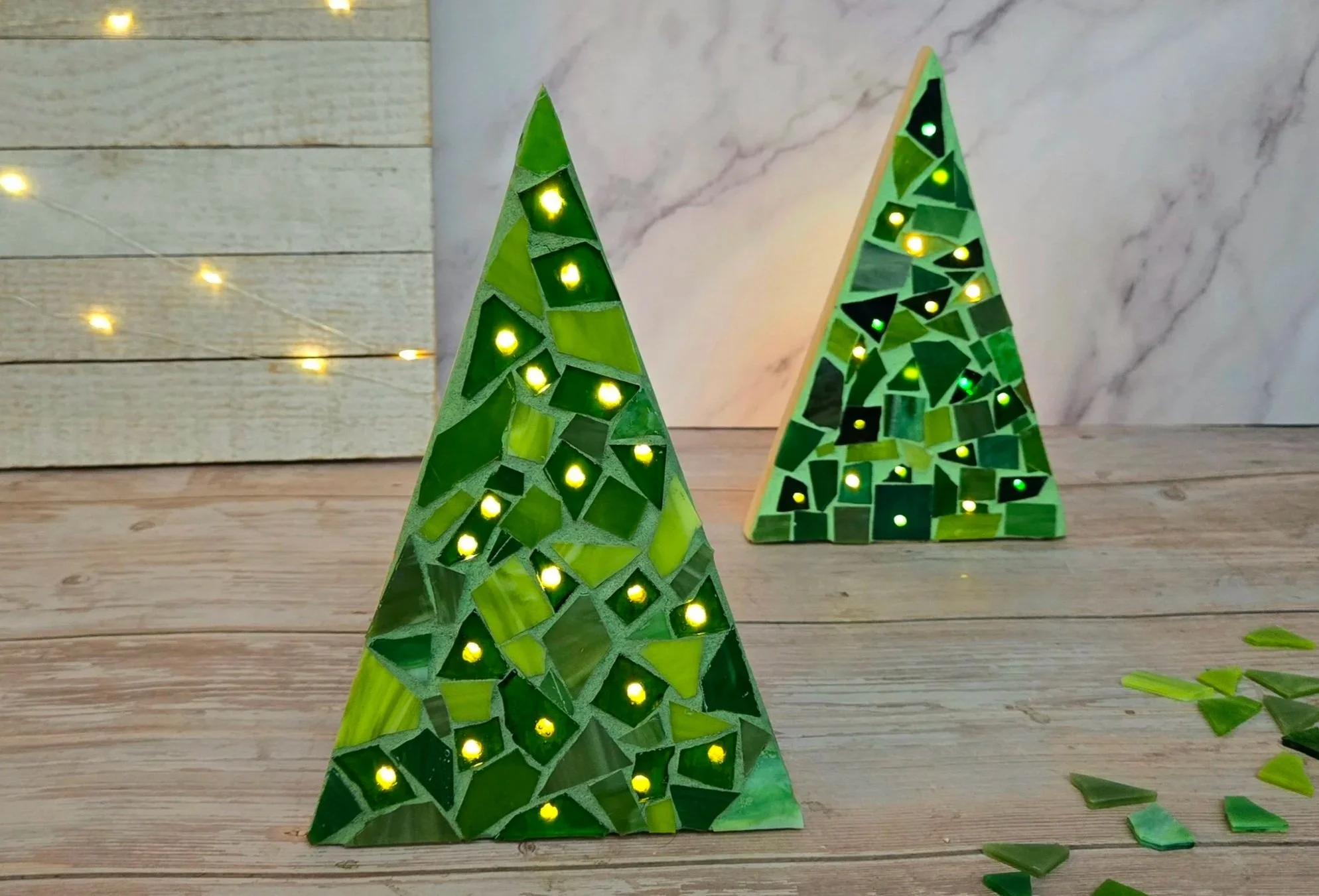 A mosaic tree, lit with lights