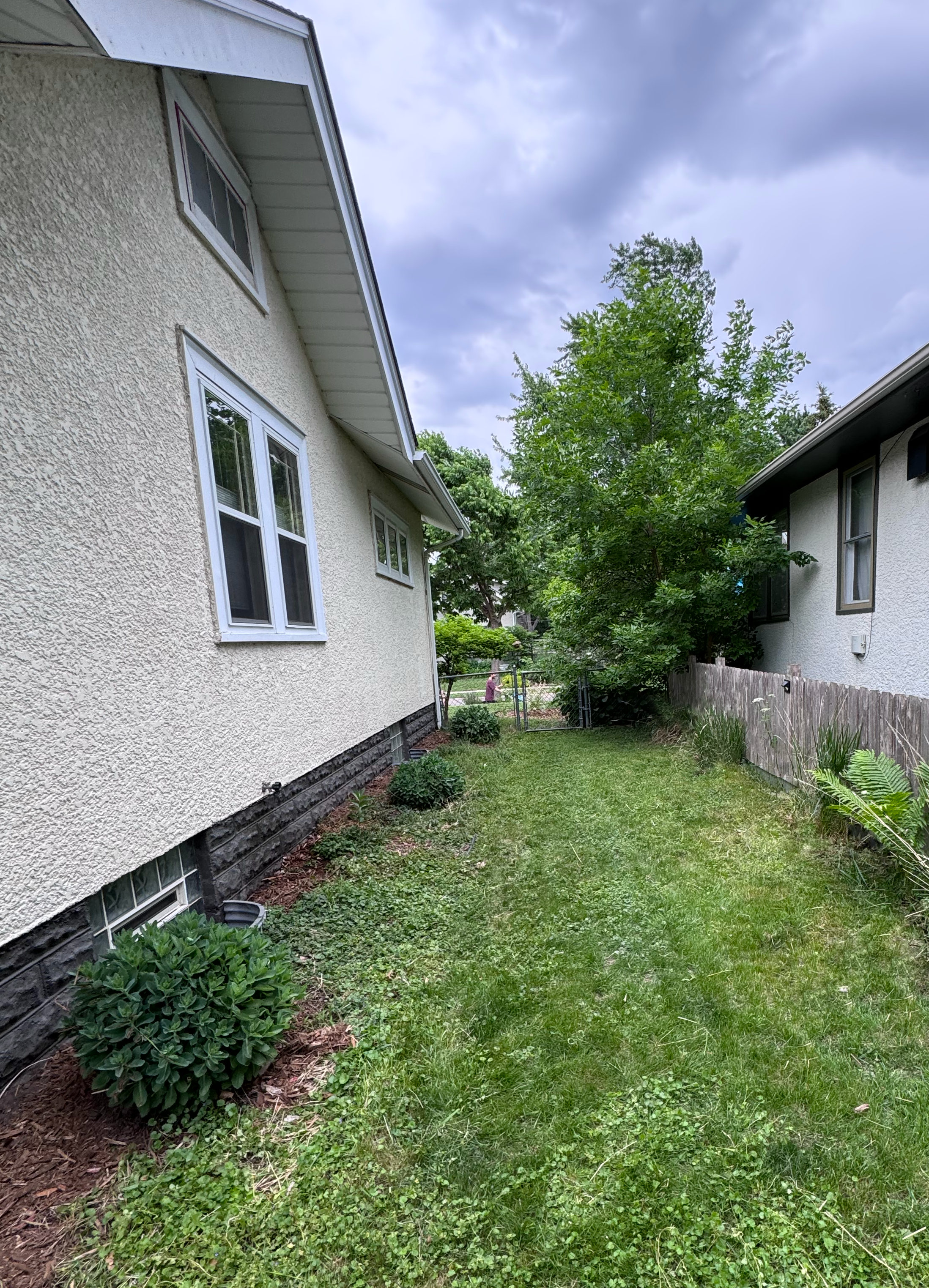 This yard had been landscaped at one point but had not been cared for in quite awhile. The sellers wanted a quick and easy transformation so that the outside matched the well-cared for inside. By relocating many plants throughout the yard, we were ab