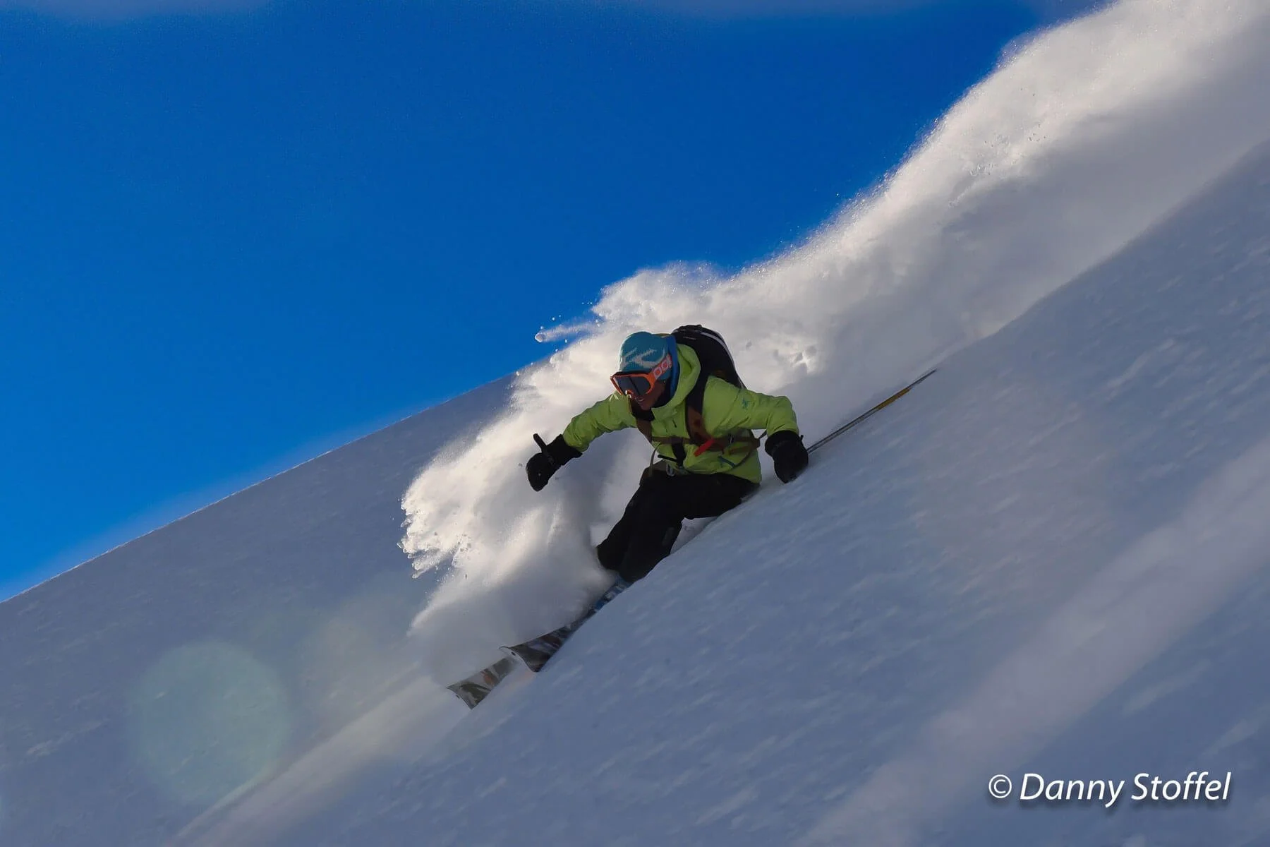 Private Ski Instruction and Ski Guiding - a photo of Lyndsay skiing an steep slope with lots of snow