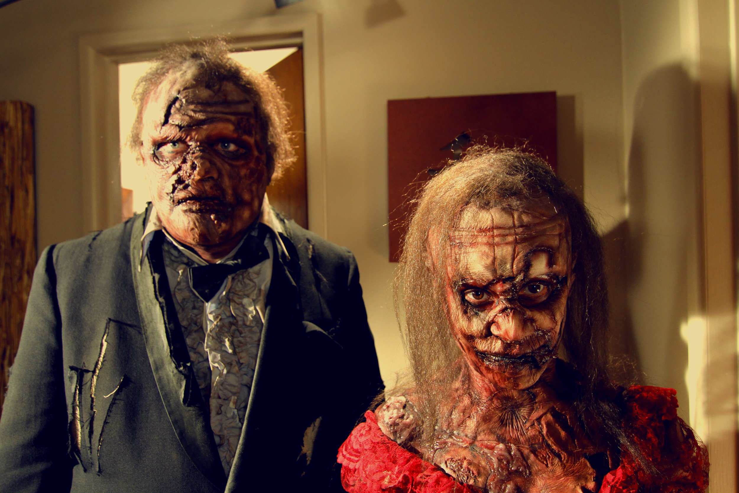 Nighttime street scene featuring a closed shop with a sign that reads 'We Accept Food Stamps.' The photo appears to be a long exposure with light streaks and reflections, including raindrops on a surface in the foreground.