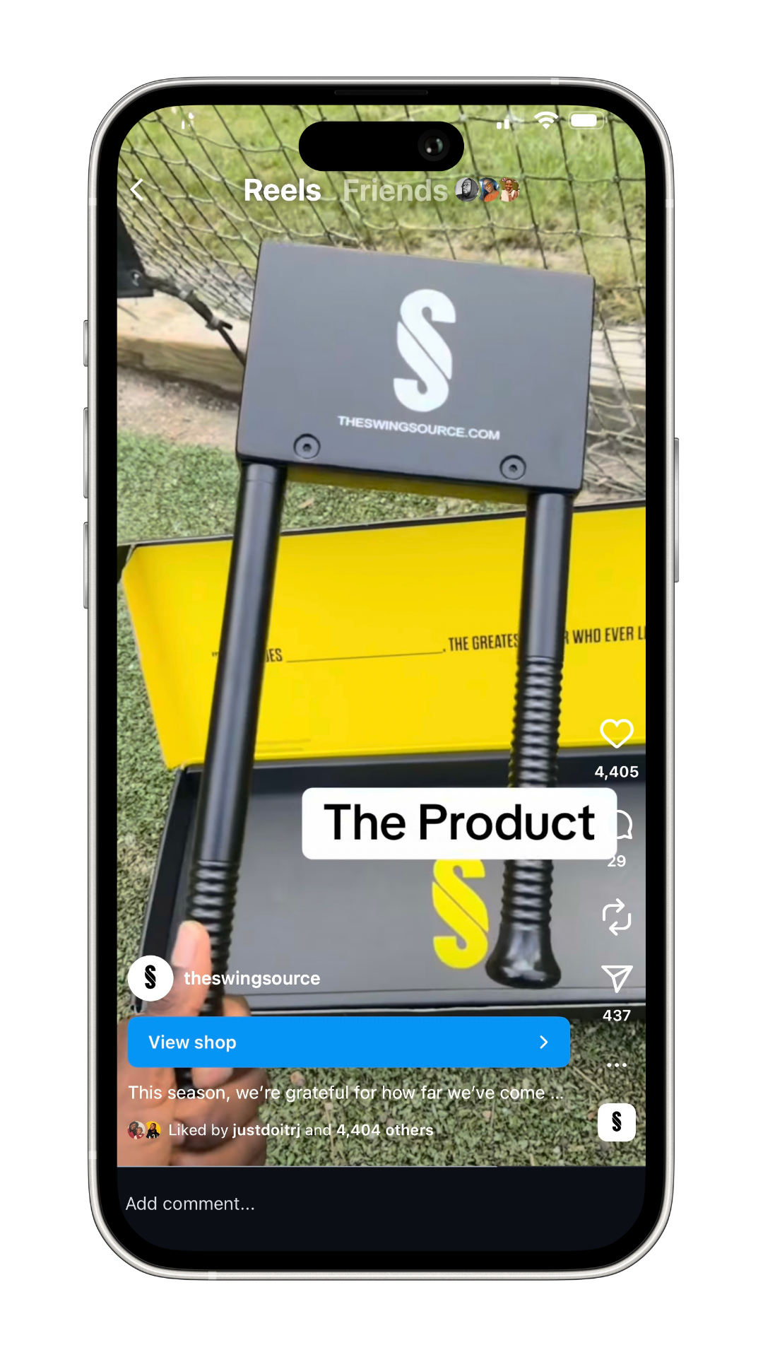 Close-up of a golf swing trainer by theswingsource in a retail box with a yellow and black design, held in front of a smartphone screen during a TikTok video.