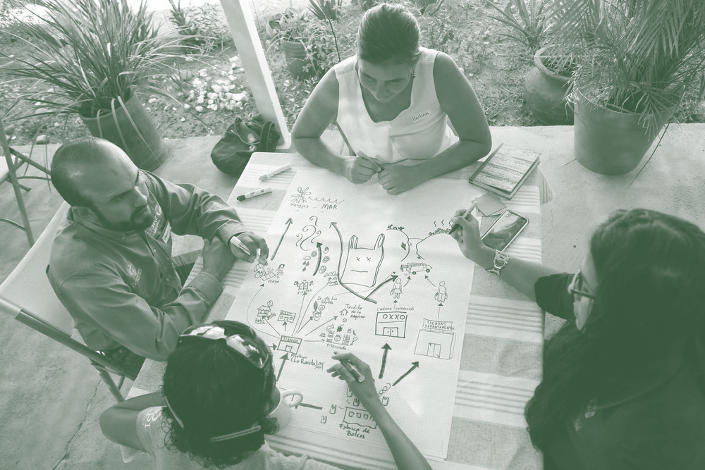Four people from above, drawing at a creative workshop facilitated by Reilly Dow