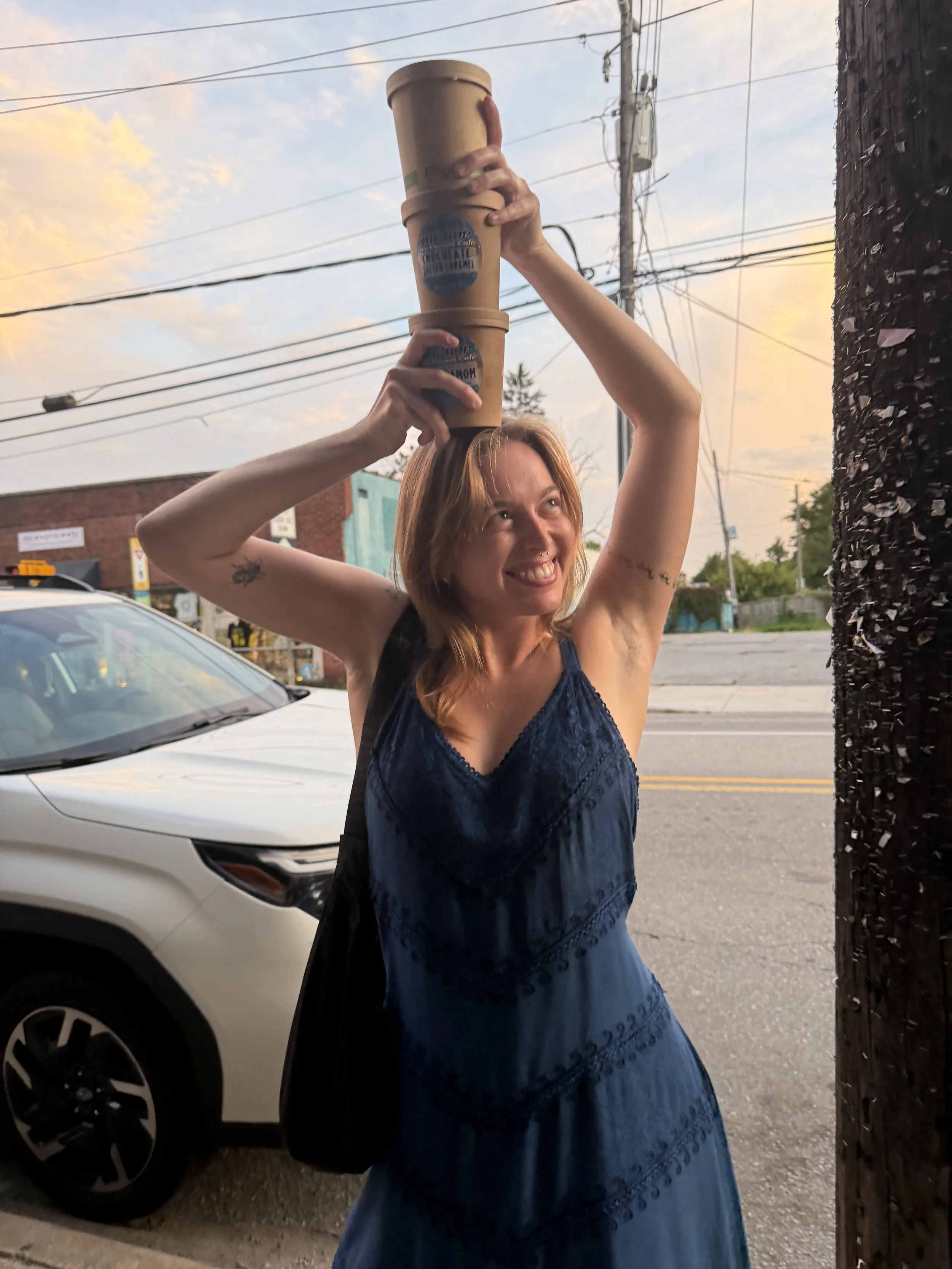 Person balancing three pints of ice cream on her head