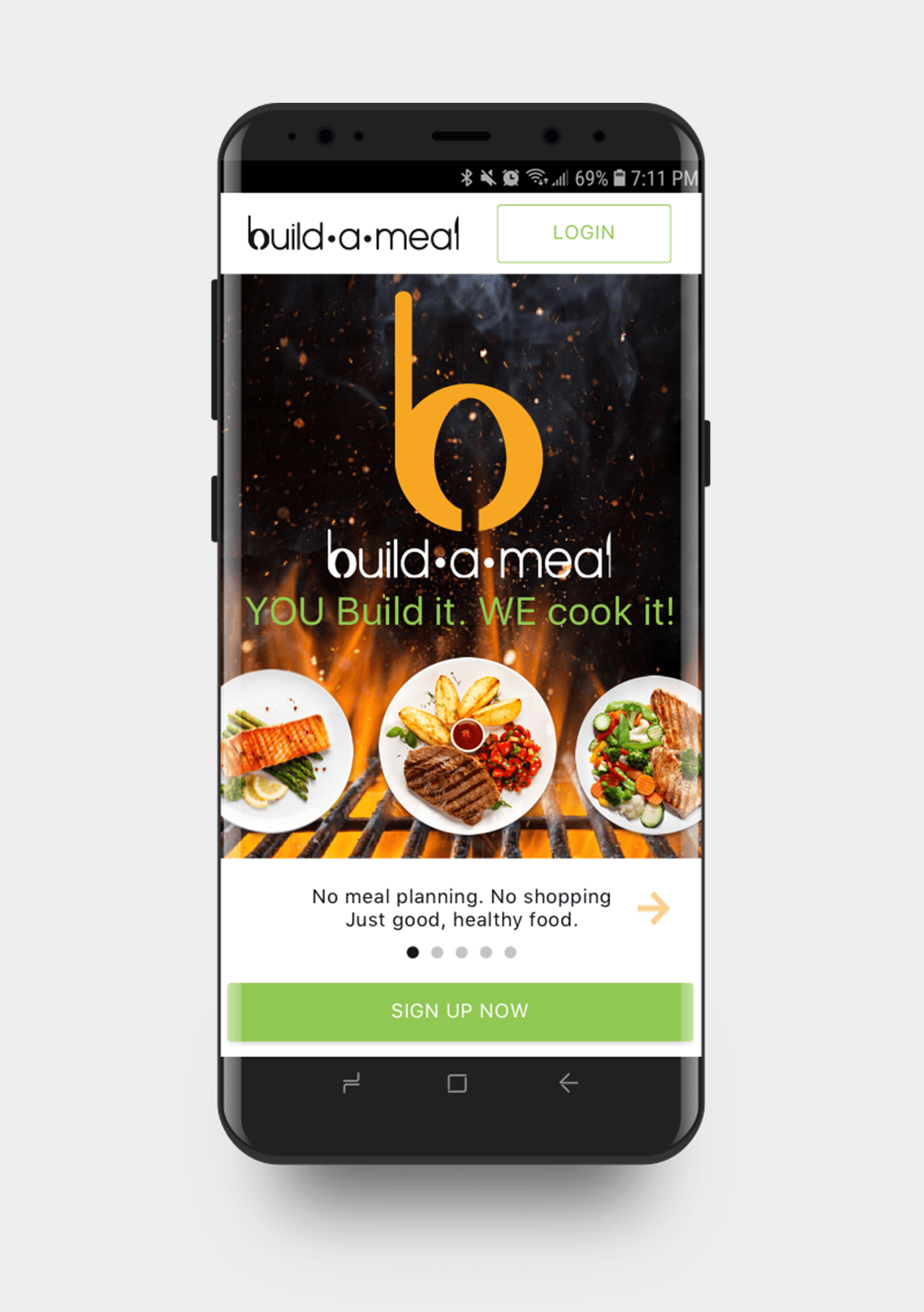 A smartphone screen showing the build-a-meal app homepage with images of various healthy dishes, a slogan 'YOU Build it. WE cook it!', and a green 'SIGN UP NOW' button.