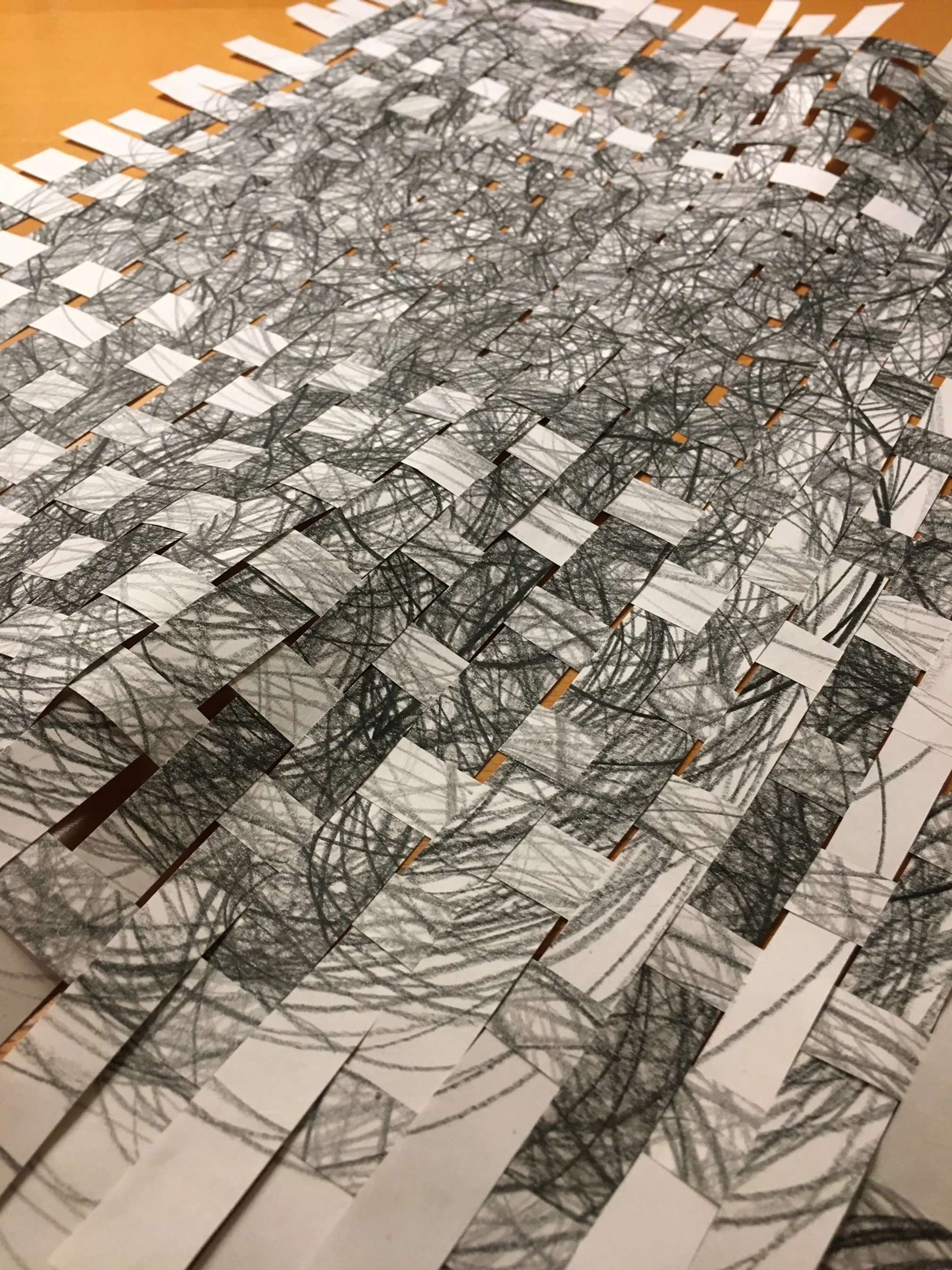 Graphite line drawing cut into strips. Strips are woven into an abstract piece.