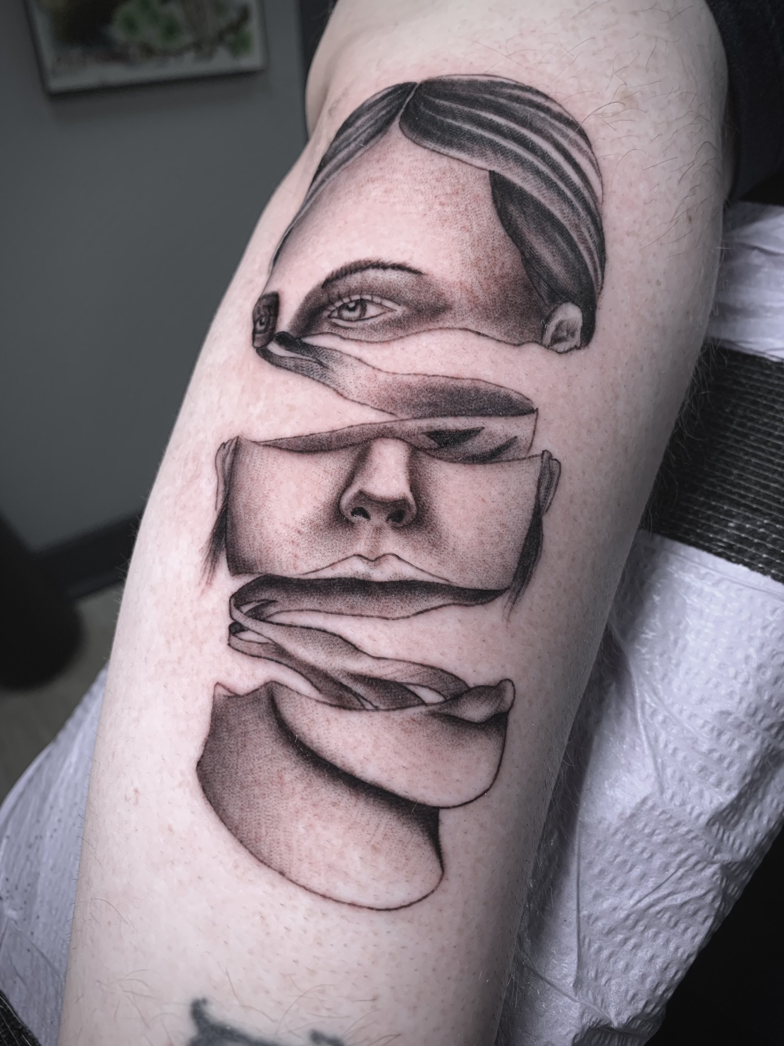 Unique face tattoo design by Jon Santos, featuring a creative ribbon-style effect that adds depth and movement. This custom piece showcases expert shading, precise linework, and a bold artistic concept. Perfect for clients looking for innovative, hig