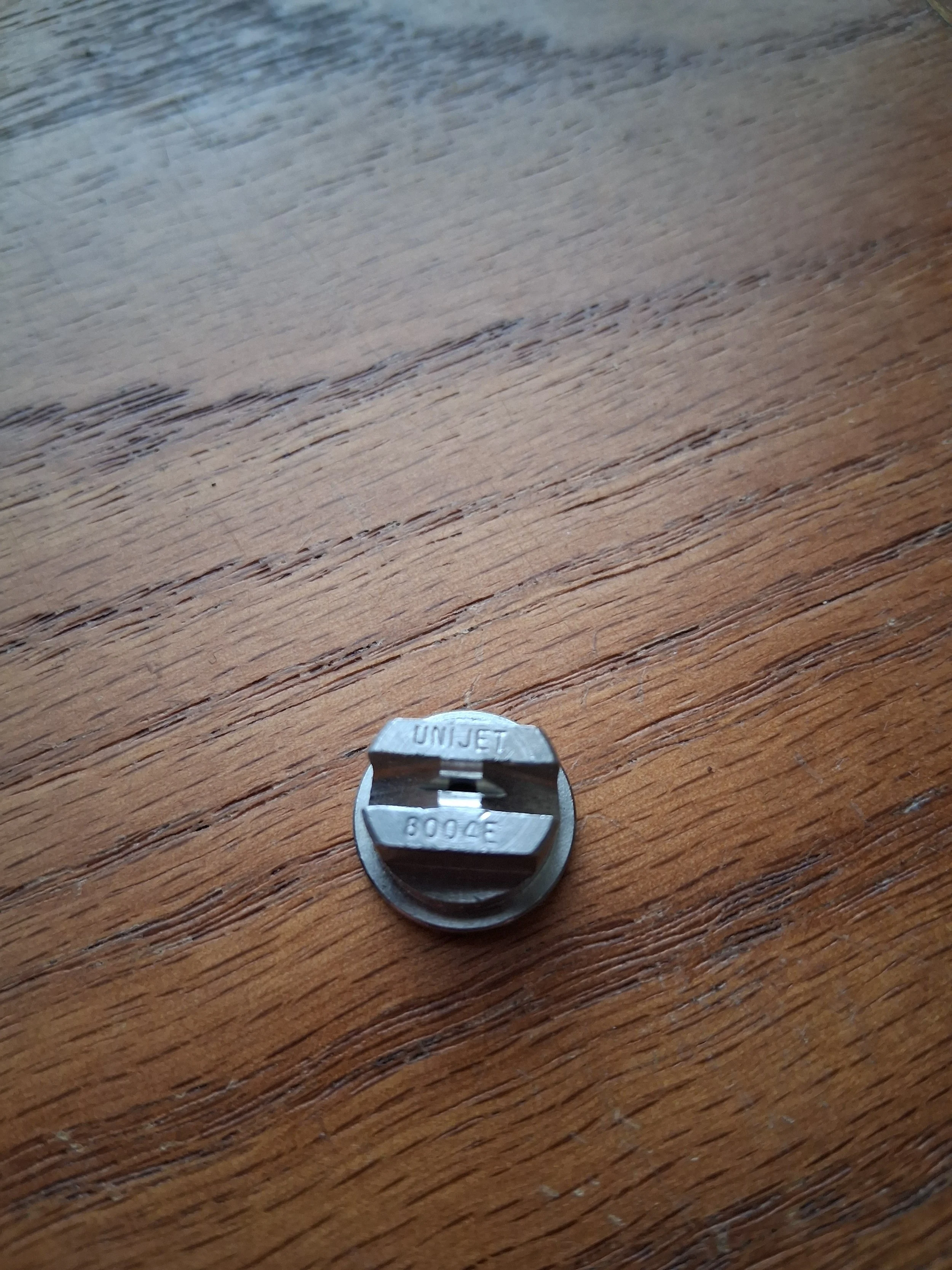 Stainless steel 8004E TeeJet nozzle tip with an 80-degree even spray pattern for carpet cleaning wands