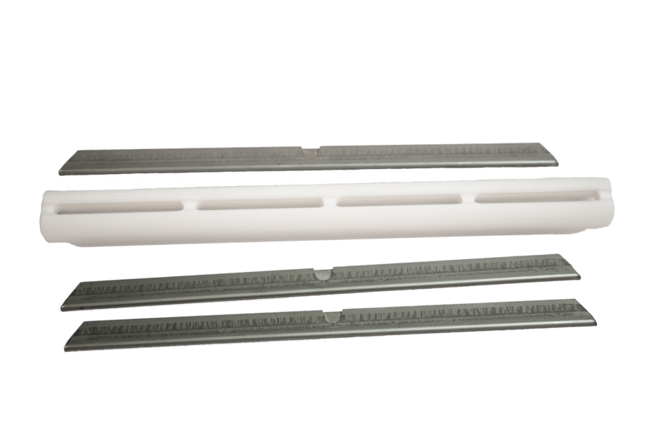 Close-up of a white Teflon AC33-TEF wand glide with a universal slotted design, engineered for high-performance airflow and smooth movement on residential and commercial carpets