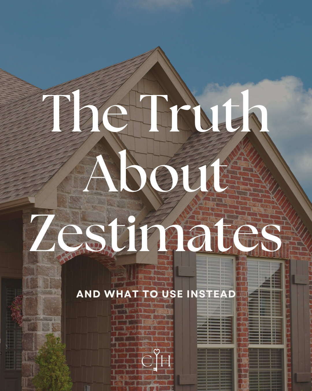 Front view of a house with brick and stone exterior walls, gable roof with shingles, and windows with blinds, under a partly cloudy sky.