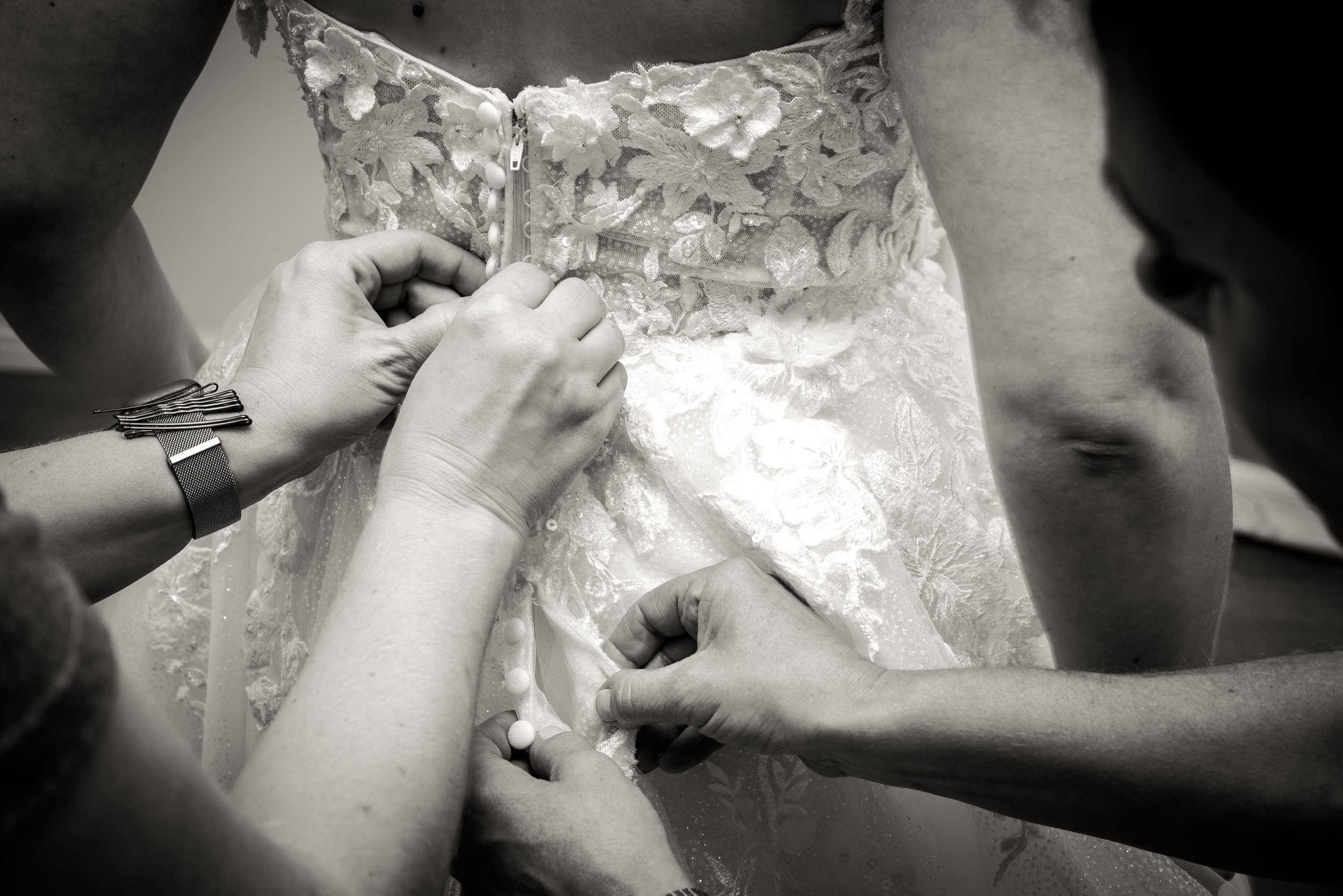 Bride putting on her wedding dress.