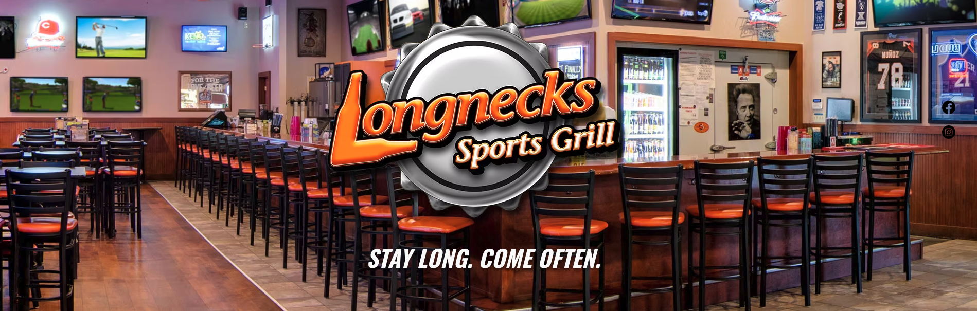 Interior of Longnecks Sports Grill with bar seating and multiple TV screens showing sports, framed sports memorabilia on the walls, and social media icons on the right