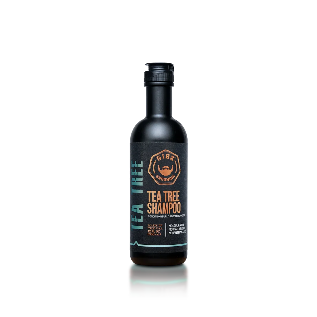 Bottle of Gib's Grooming Tea Tree Shampoo with black label, orange text, and blue accents, standing upright on a reflective surface.