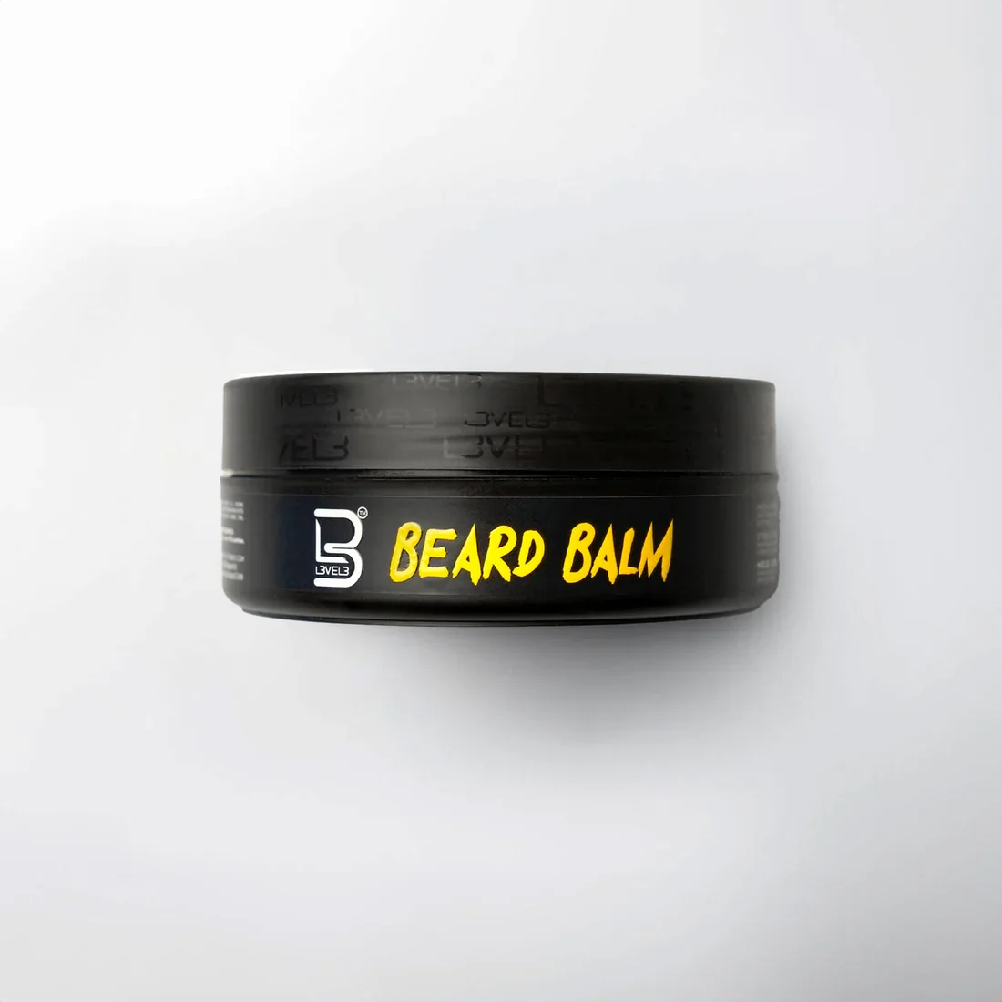 Black container of beard balm with yellow and white text on a white background