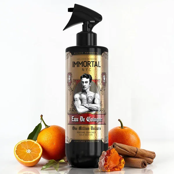 A black spray bottle labeled 'Immortal NYC Eau De Cologne' with a vintage-style label. The bottle is surrounded by oranges, cinnamon sticks, a slice of orange, and amber resin.