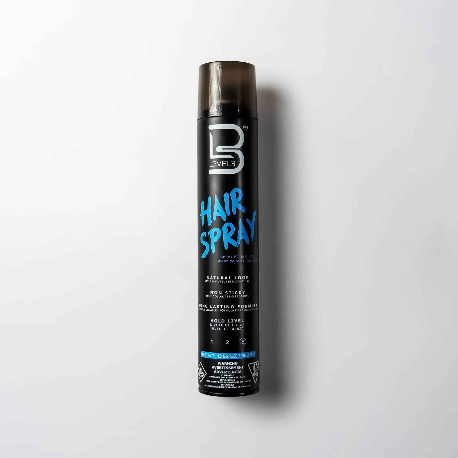 Black can of L3VEL3 hair spray with blue and white label, standing upright on white background.