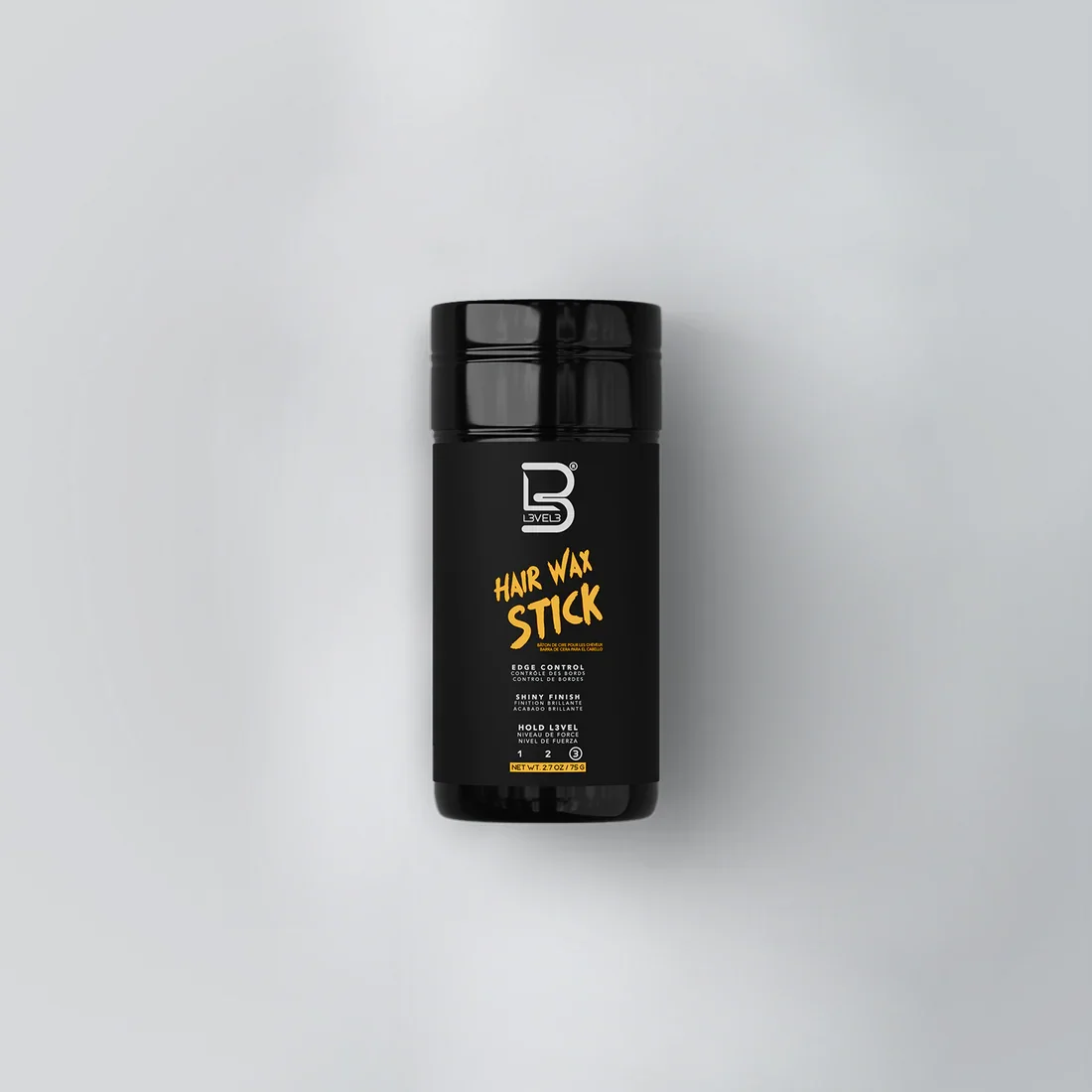 Black bottle of Level 3 Hair Wax Stick with orange and white text on a light gray background.