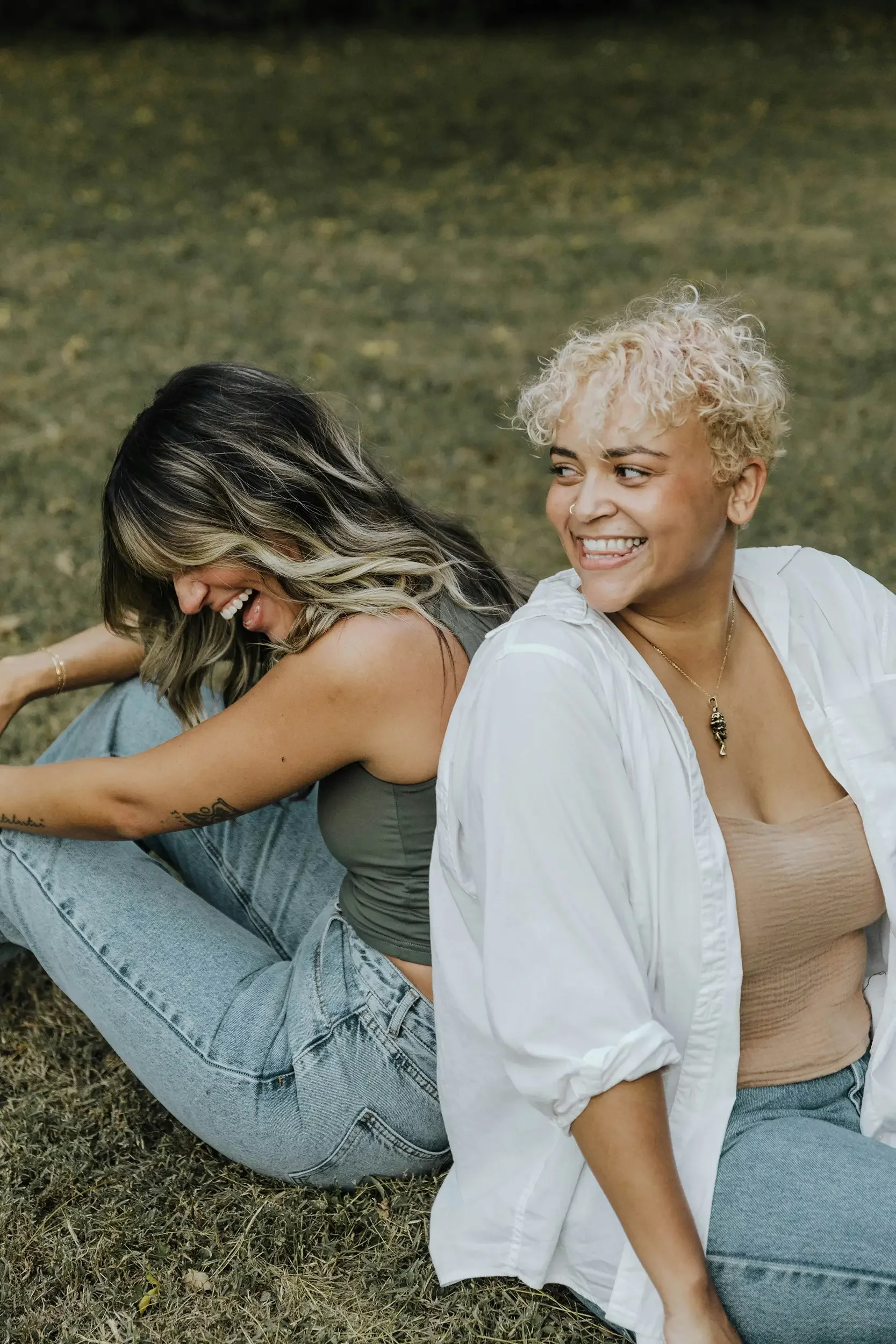 Two women laughing together after online therapy with Your Path Through Counseling in Michigan