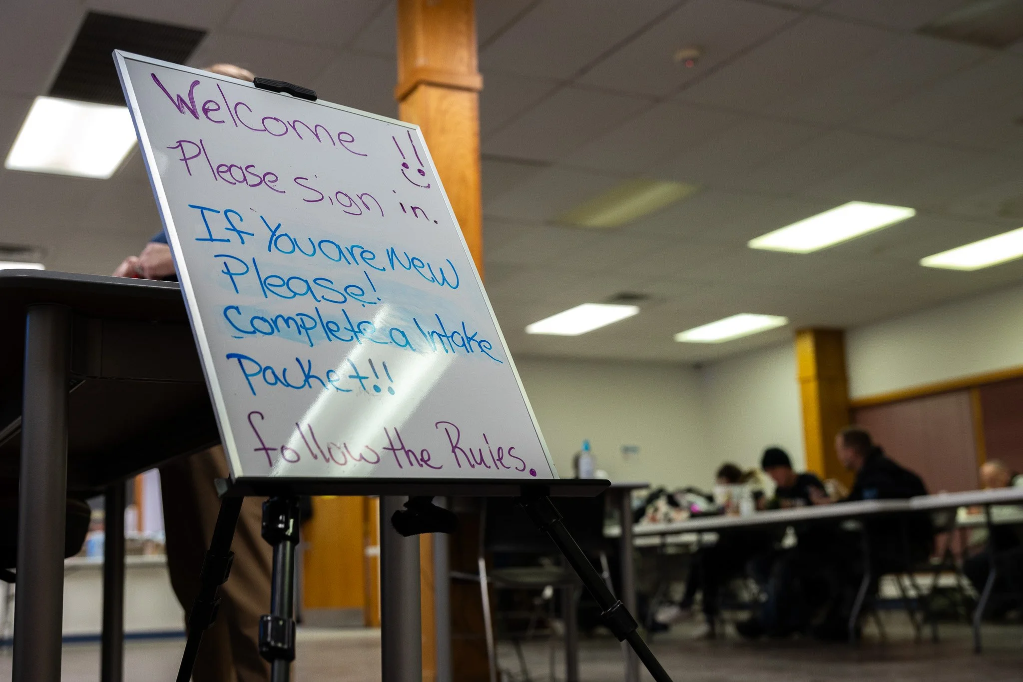An entrance sign greeting clients at the Price Hall Warming Center Feb. 2 in downtown Muncie. Volunteers at Price participate in serving clients food, assisting in applying for federal aid programs and more. 