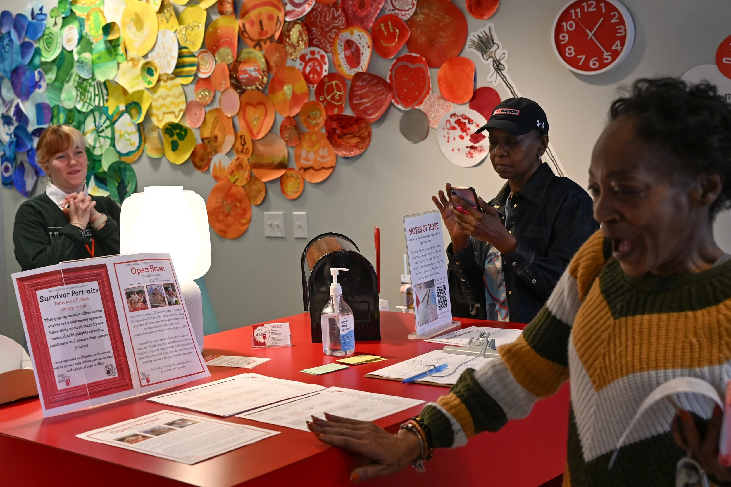 Taylor, the program and outreach coordinator for Little Red Door Cancer Agency, speaks with a client of the nonprofit during the open house program Feb. 19 in Indianapolis. The nonprofit agency provides free resources for cancer patients that extend 