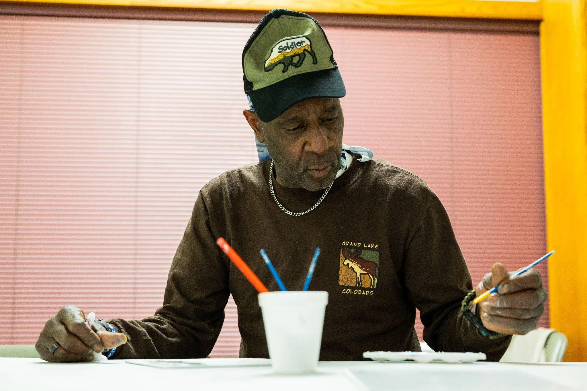 Price Hall Warming Center client Frederick Timberlake paints a picture Feb. 2 in downtown Muncie. Timberlake is an individual without housing who has been coming to Price Hall for shelter during the Winter.