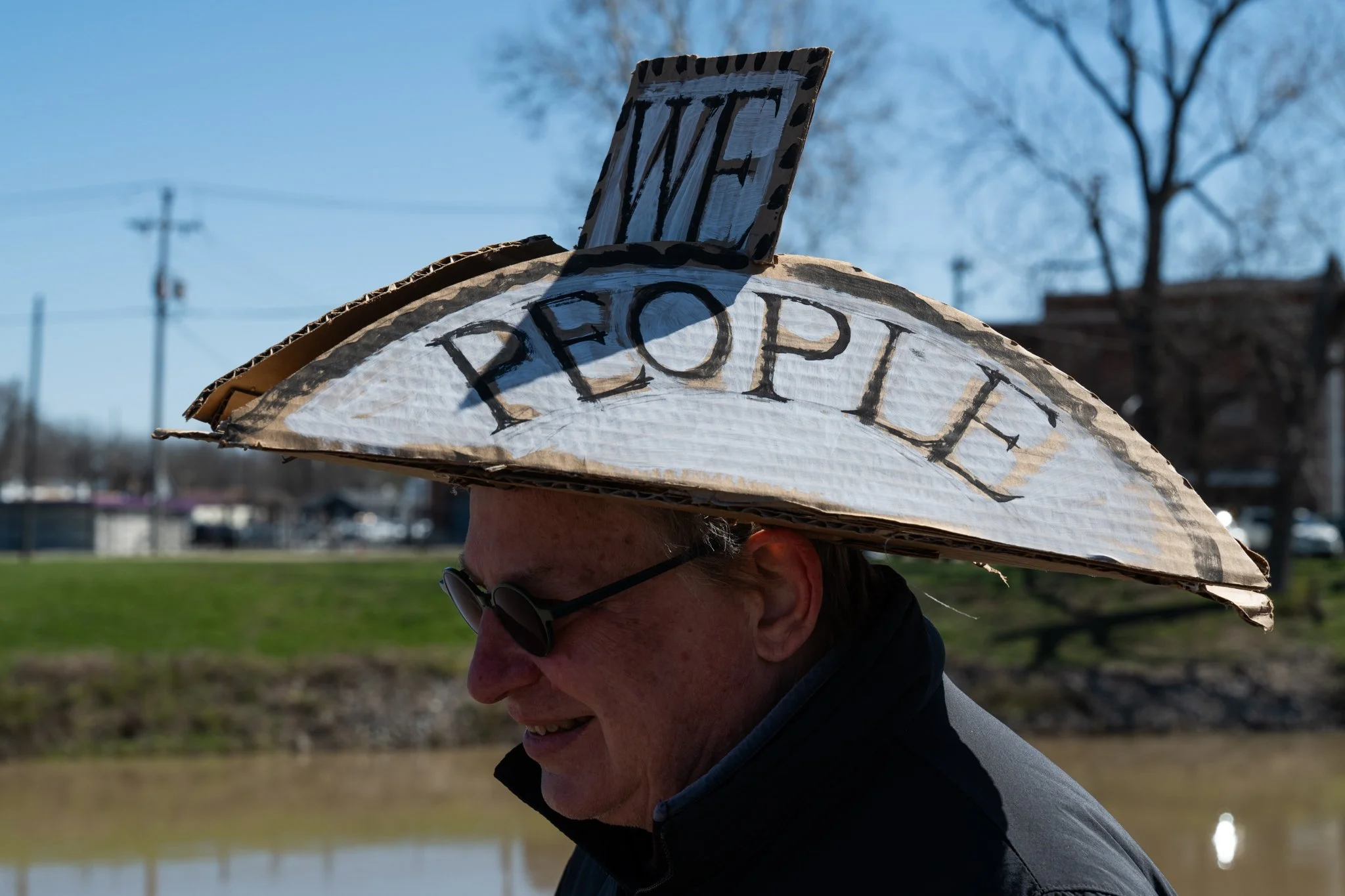 A protester wears a hand-made cardboard hat during the ‘No Kings 3’ protest March 28 at the Fallen Heroes Memorial Bridge. 