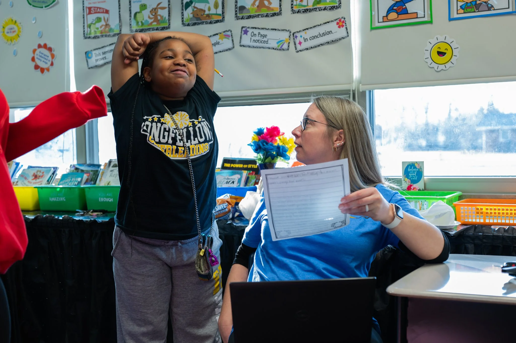 Raevyn Buntyn, a student in Longfellow Elementary's "XSTREAM" program, submits her assignment to her teacher, Mrs. Foster, the lead teach for their class Jan. 23 at Longfellow Elementary.