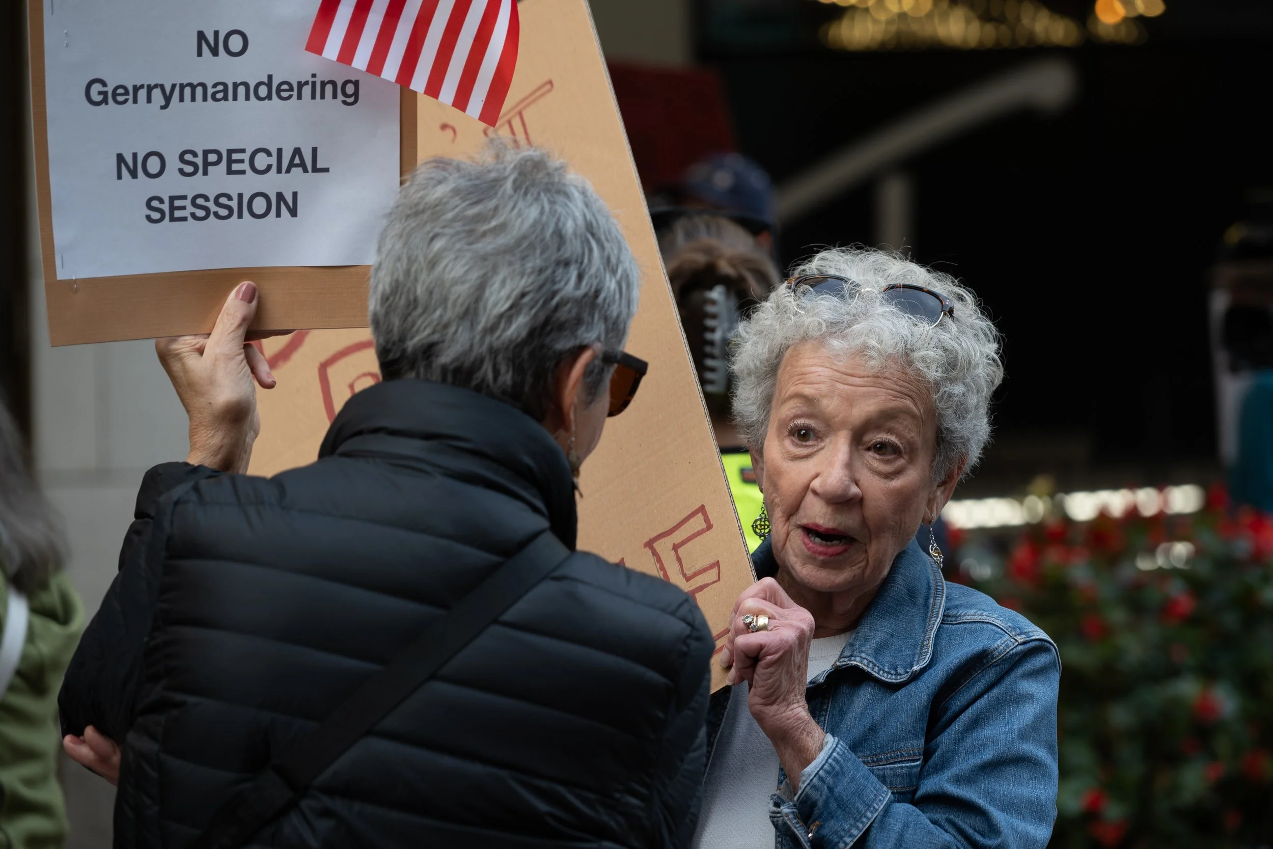 Protestors against mid-cycle redistricting speaking between chants October 2025 at the Indiana Roof Ballroom. 