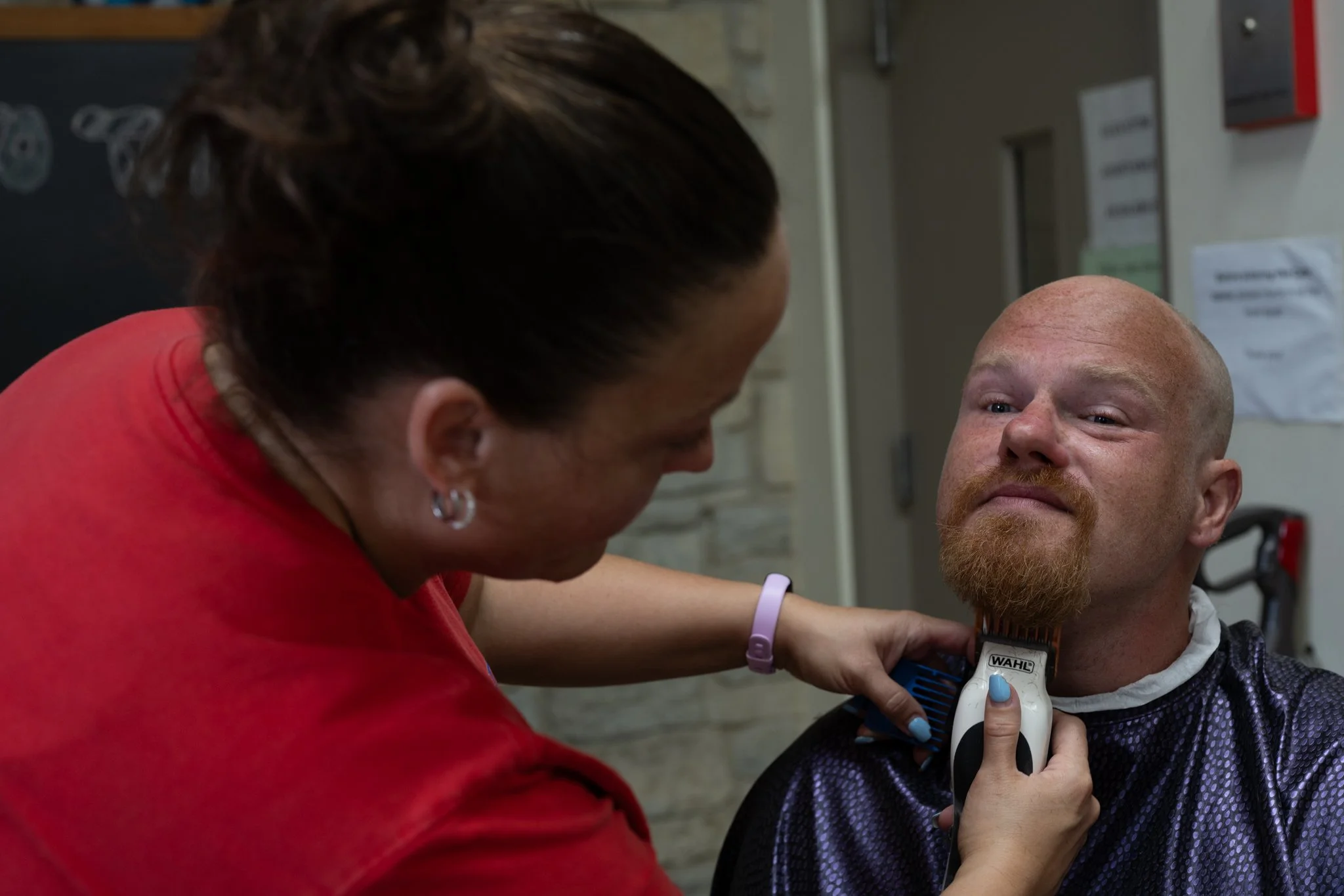 Senior member leader Malissa Howell grooms Gizmo, another member of the Recovery Cafe Muncie April 4 in Muncie, Indiana. The cafe offers services to the community to assist people undergoing any kind of recovery.