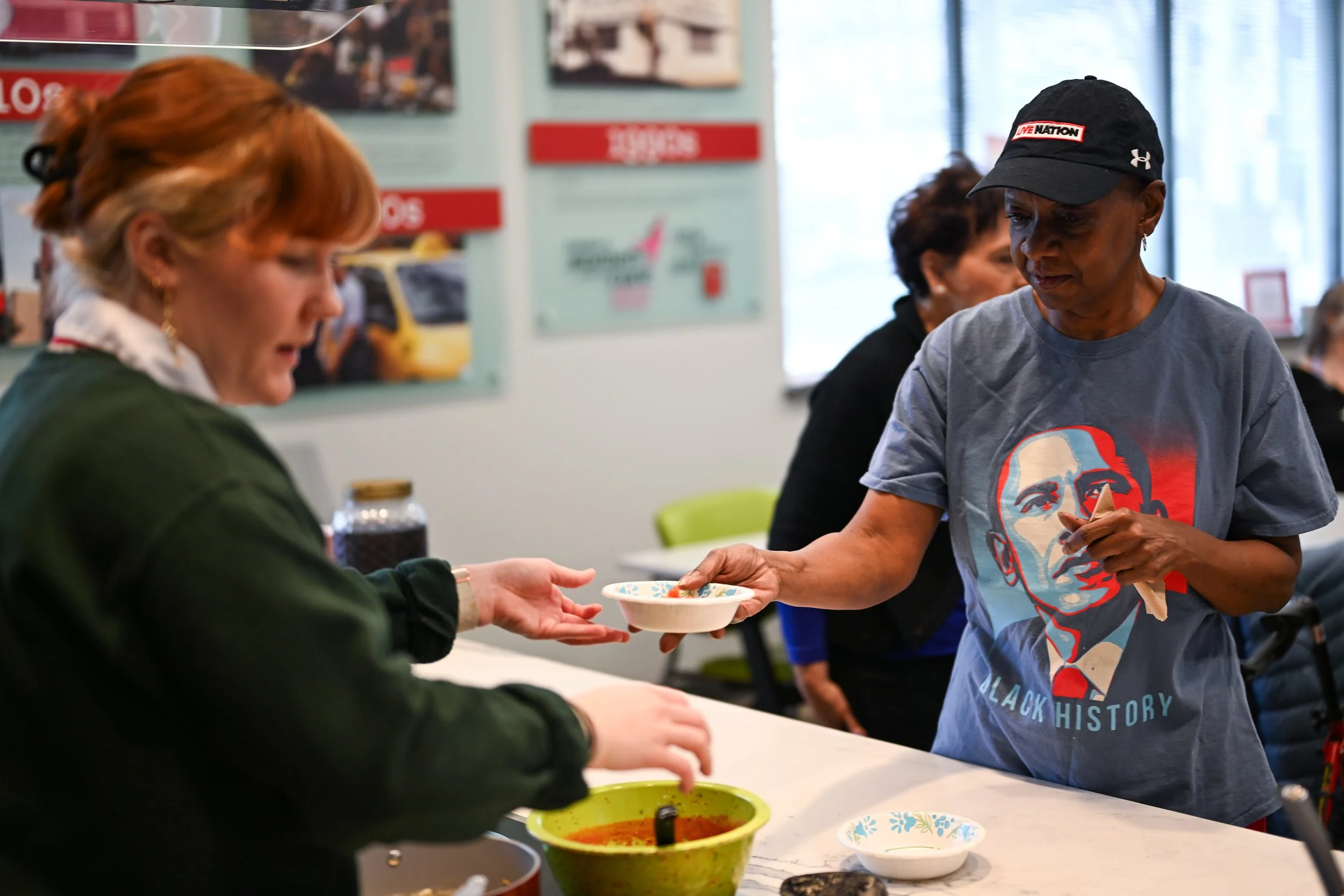 Little Red Door client Reneé Jackson-Lester is served food during Little Red Door Cancer Agency’s open house event Feb. 19 in Indianapolis. Lester was diagnosed with a cancerous brain tumor and underwent removal surgery that had the potential to elim