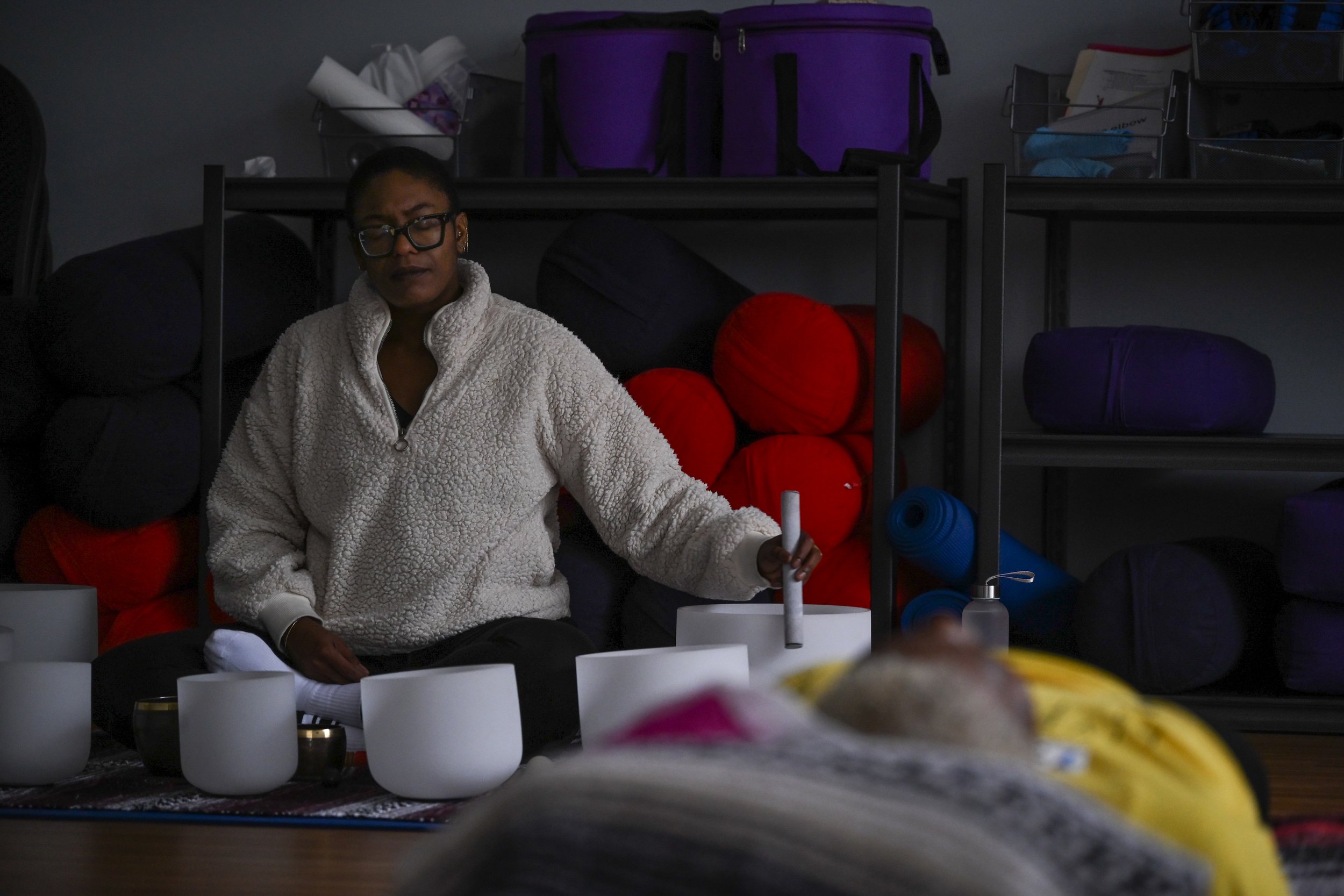Uma Behati, a worker at Little Red Door Cancer Agency, performs a meditative sound bath for clients of the nonprofit Feb. 19 in Indianapolis.
