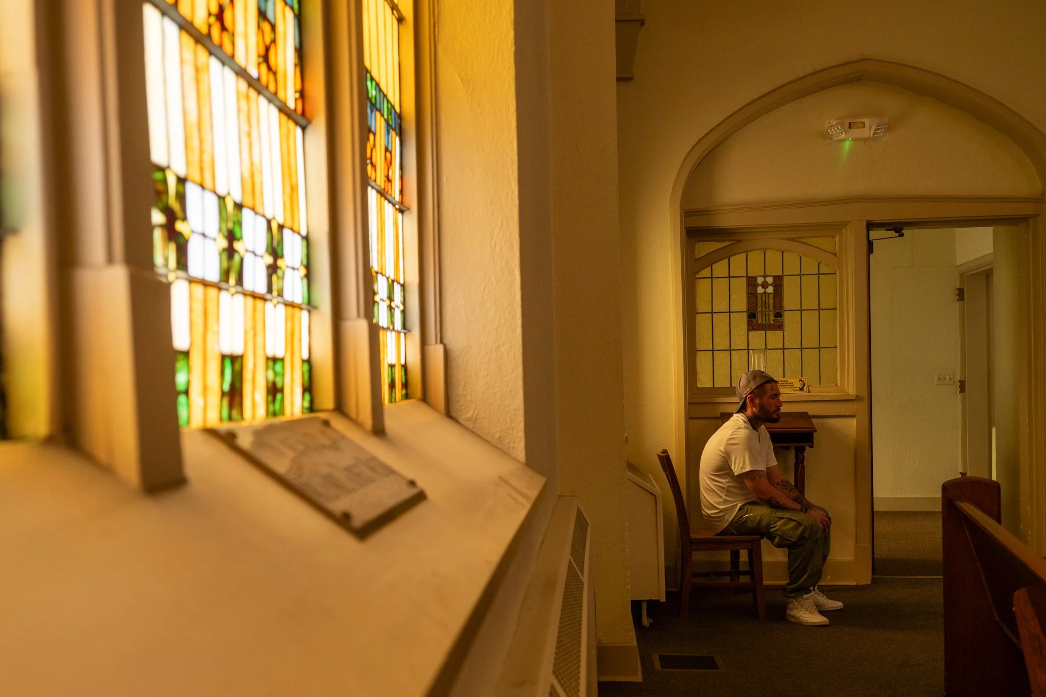 Recovery Cafe Muncie member Ed sits and watches a performance on the stage of the sanctuary of the building April 4 in Muncie, Indiana.