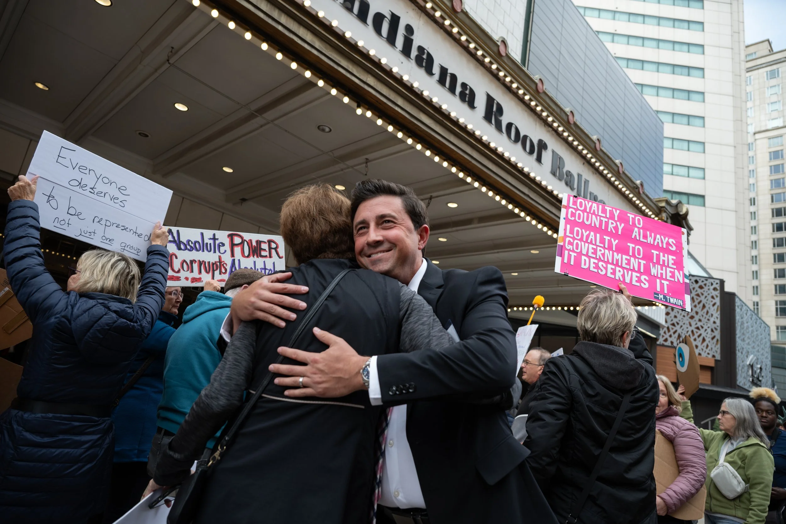 A member of the Indiana GOP greets a familiar face among protestors against mid-cycle redistricting October 2025 in Indianapolis, Indiana.