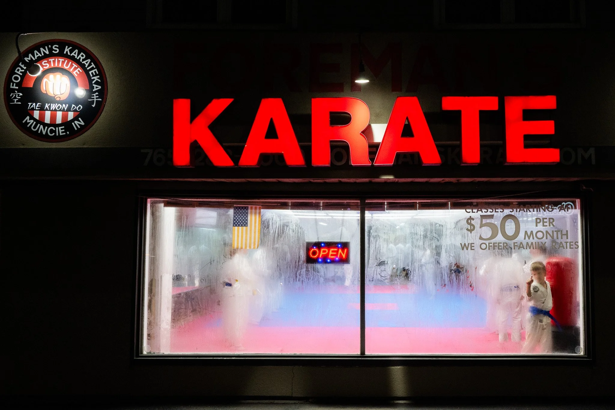 A young student of David Foreman's Karate Studio doodles on an exterior window during a session Nov. 24 in Muncie, Indiana.