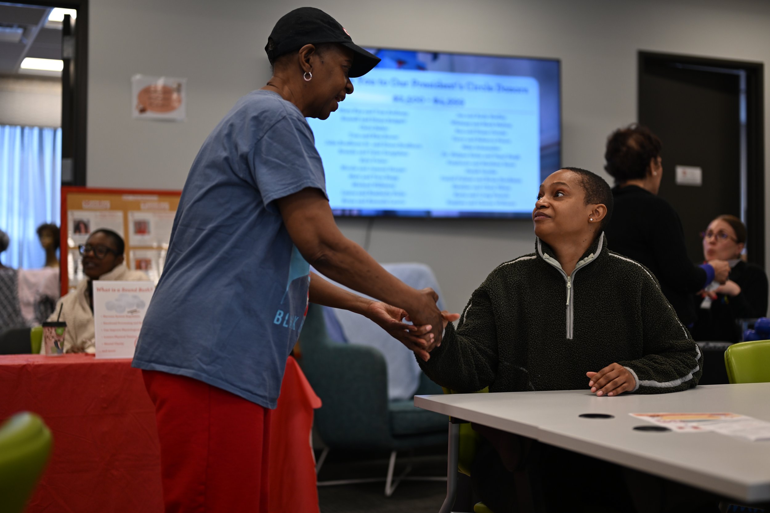 Reneé Jackson-Lester greets another client of the Little Red Door Cancer Agency during the nonprofit’s open house event Feb. 19 in Indianapolis.