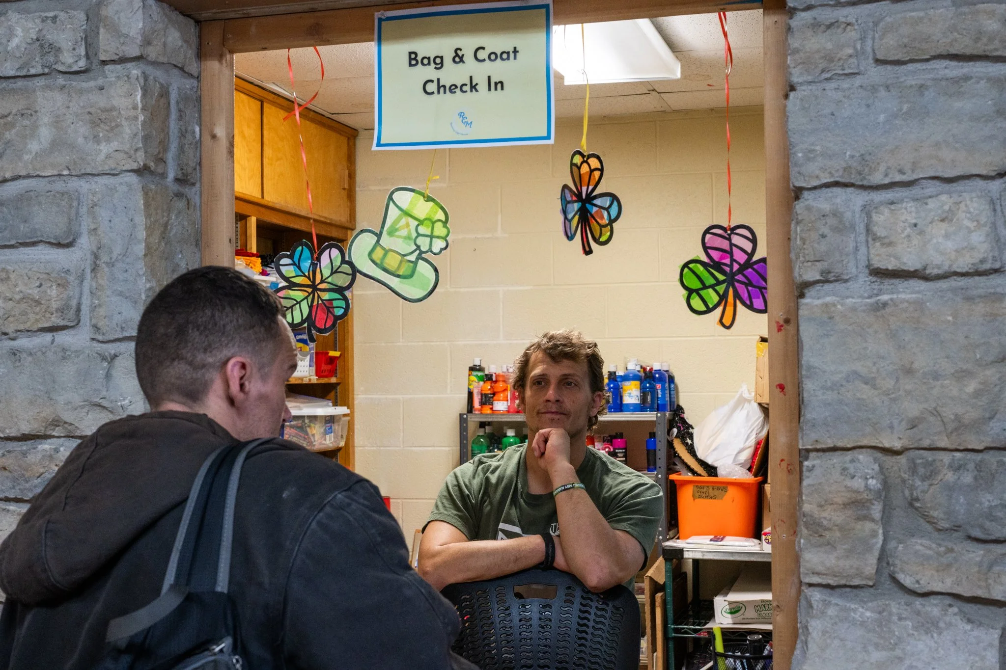 Mathew Albert, the data and hospitality manager for the Muncie Recovery Cafe, greets a guest at the bag check-in April 4 in Muncie, Indiana. The Recovery Cafe opens its doors to guests dealing with issues of drug addiction, alcohol abuse, mental heal