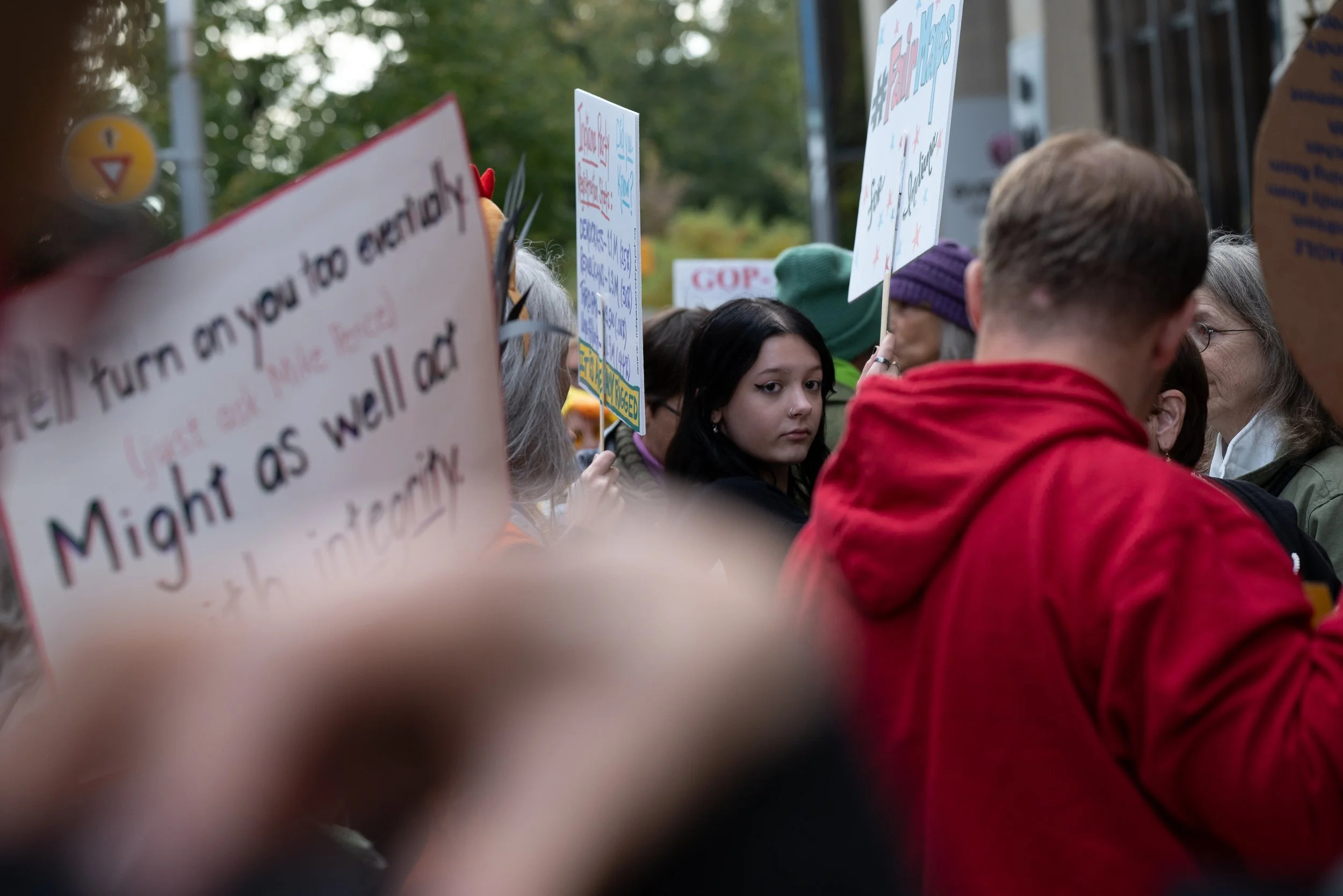 A young protest attendee voicing their demand against mid-cycle redistricting October 2025 at the Indiana Roof Ballroom.