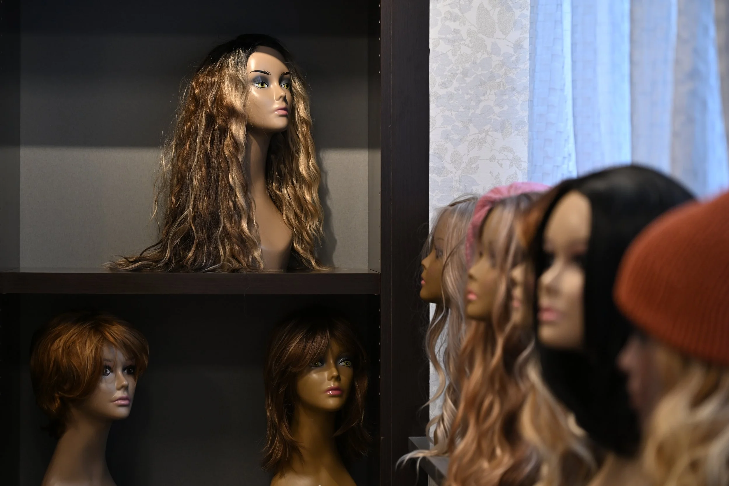 Wigs arranged on stands in Michelle’s Boutique, a service provided by Little Red Door Cancer Agency, pictured Feb. 19 in Indianapolis. Clients of Little Red Door are given one free wig with their cancer diagnosis.