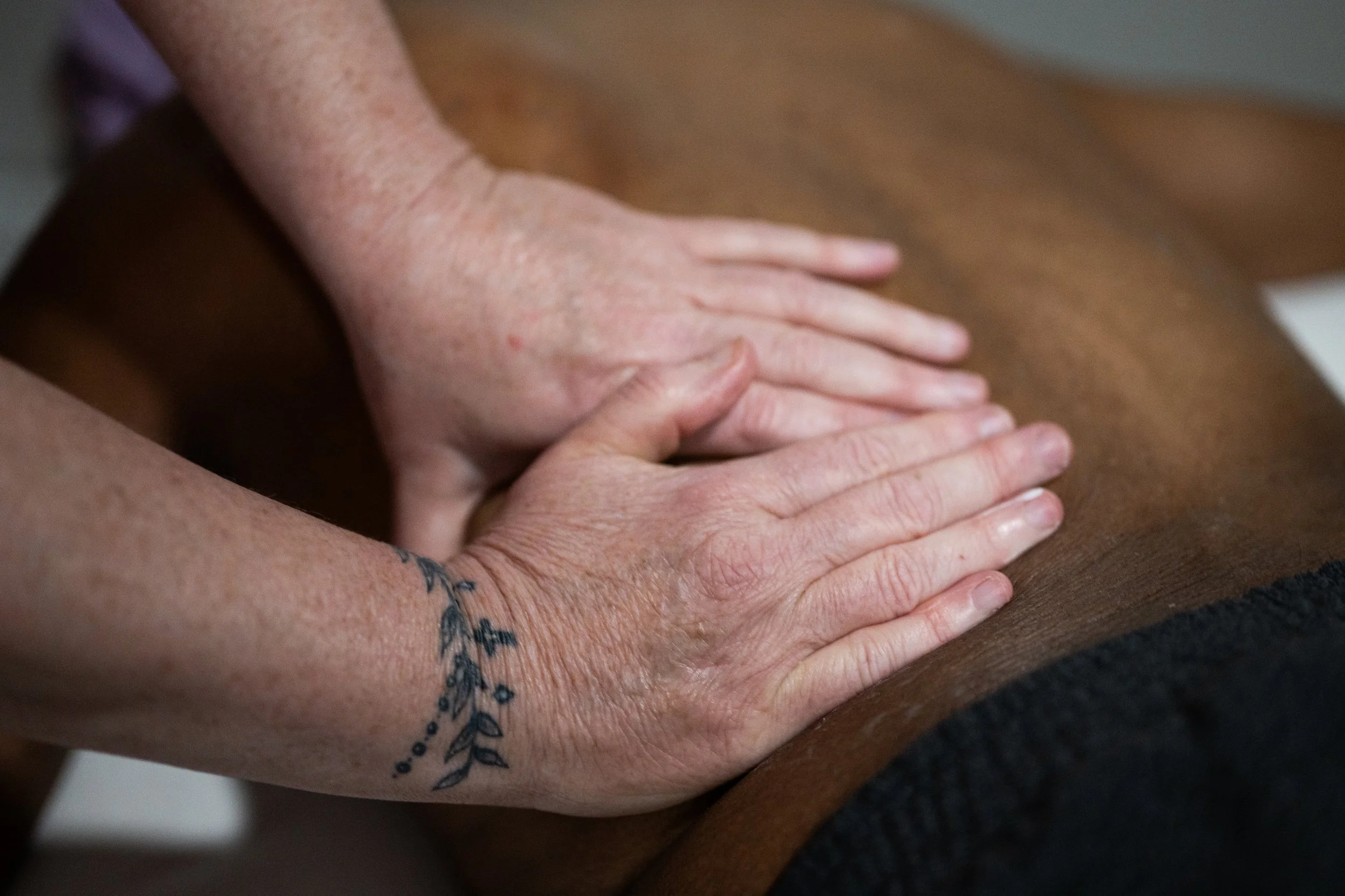Massage therapist Angie Simon performs an oncology massage on Little Red Door Cancer Agency client Earlier Dewayne Davis. Oncology massage therapy requires specified training and certification to perform.
