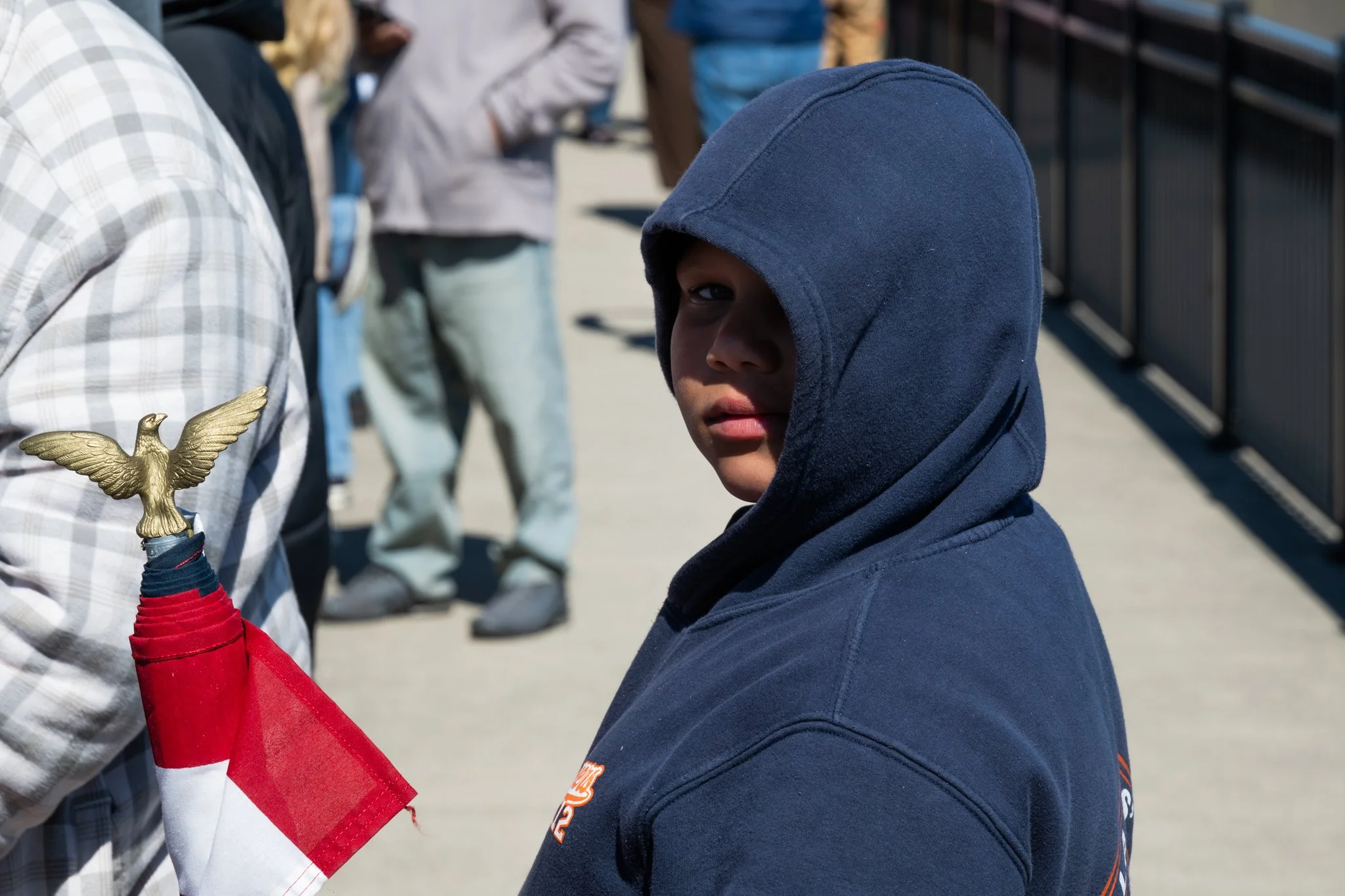 A young protester, Dominic Redwine, poses for a portrait during the ‘No Kings 3’ protest March 28 at the Fallen Heroes Memorial Bridge.