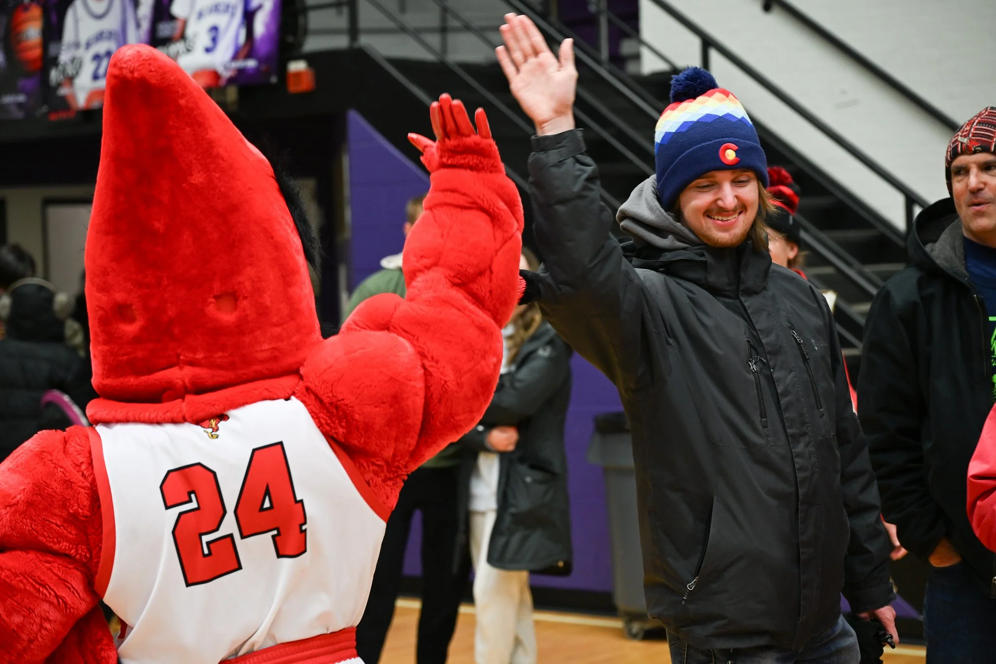 Charlie Cardinal high-fives an attendee of Muncie Mission's Walk a Mile event Feb. 21 in Muncie, Indiana. 