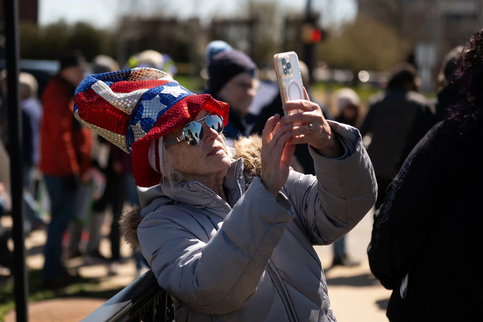 A protester snaps a picture during the ‘No Kings 3’ protest March 28 at the Fallen Heroes Bridge. 