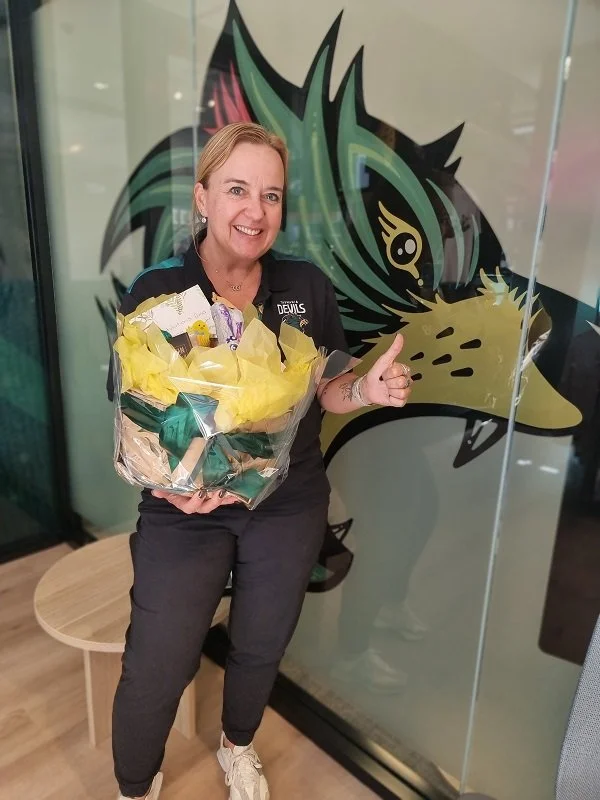 Dana from Tasmania Devils Football Club with the Easter Basket she won in the competition  at the Small Business Expo