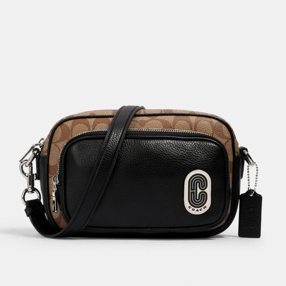 A Coach crossbody bag in brown and black, featuring a signature pattern and logo.