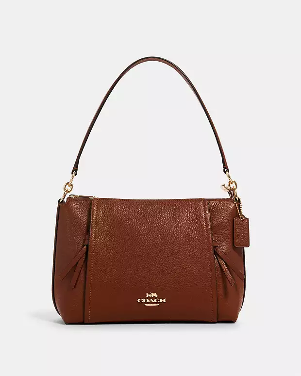 Brown leather handbag with top handle and gold accents