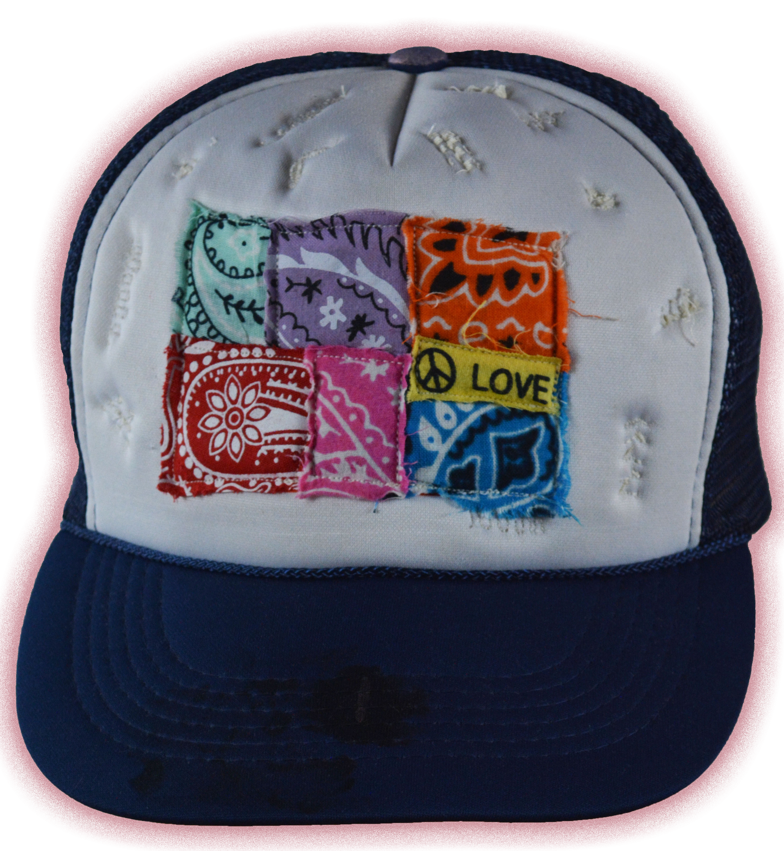 A white and navy blue trucker cap with colorful fabric patches sewn onto the front panel, including a yellow patch with a peace sign and the word 'LOVE', along with other bandana-like fabrics in red, purple, orange, pink, yellow, and blue.