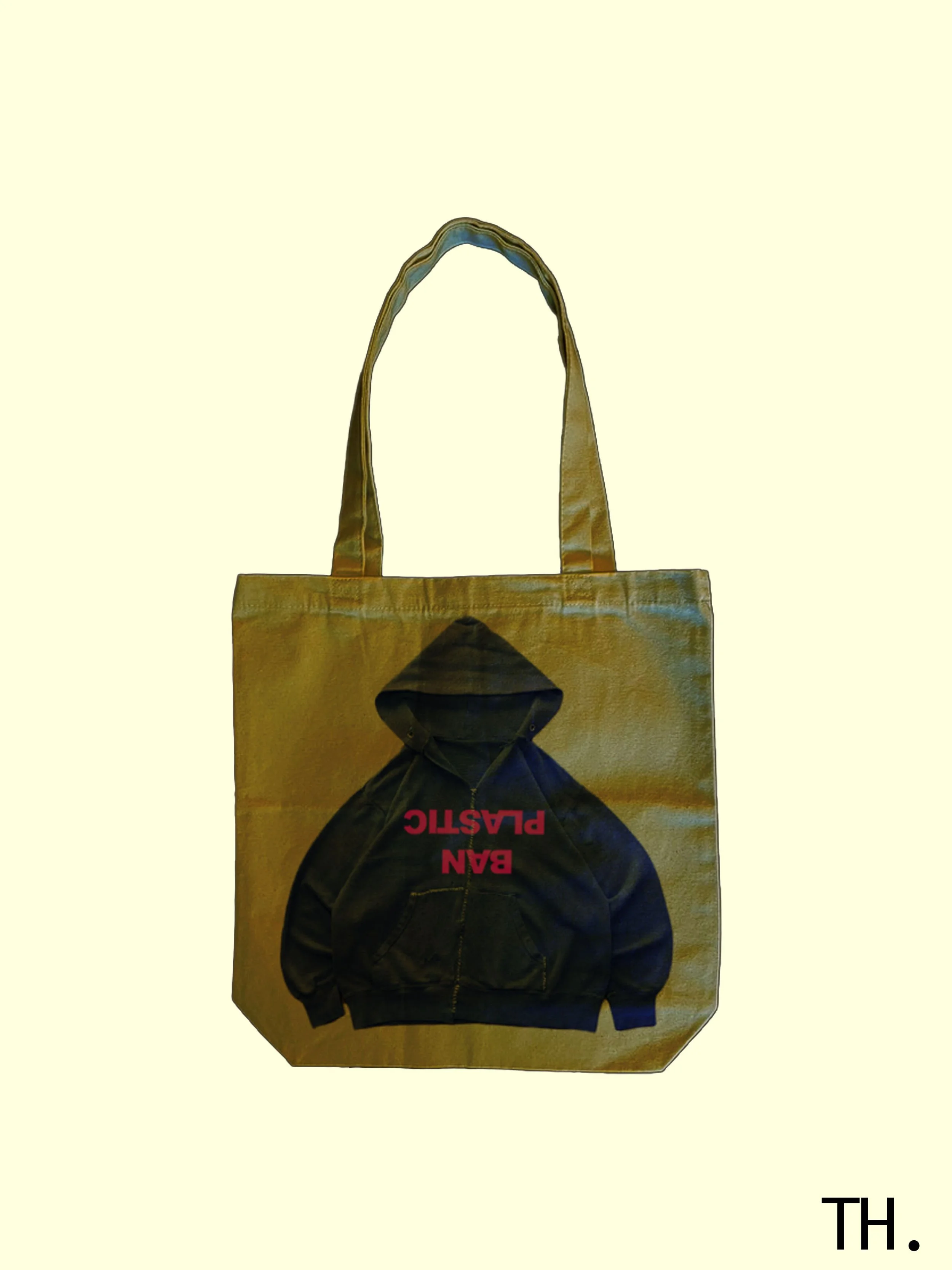 A tote bag featuring a hoodie graphic with the text 'BAN PLASTIC' in red.